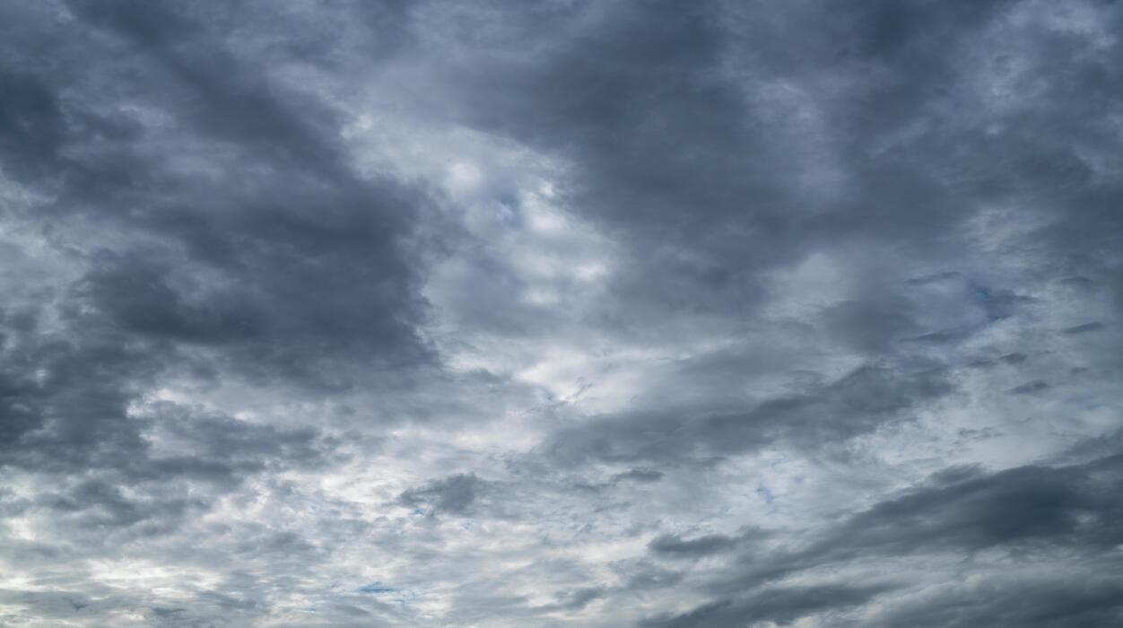 1252x700 Overcast sky. Dramatic gray sky and dark clouds before rain in rainy season. Cloudy and moody sky. Storm sky. Gloomy and moody background. Overcast clouds. Sad, lonely, and death abstract background. 26329624