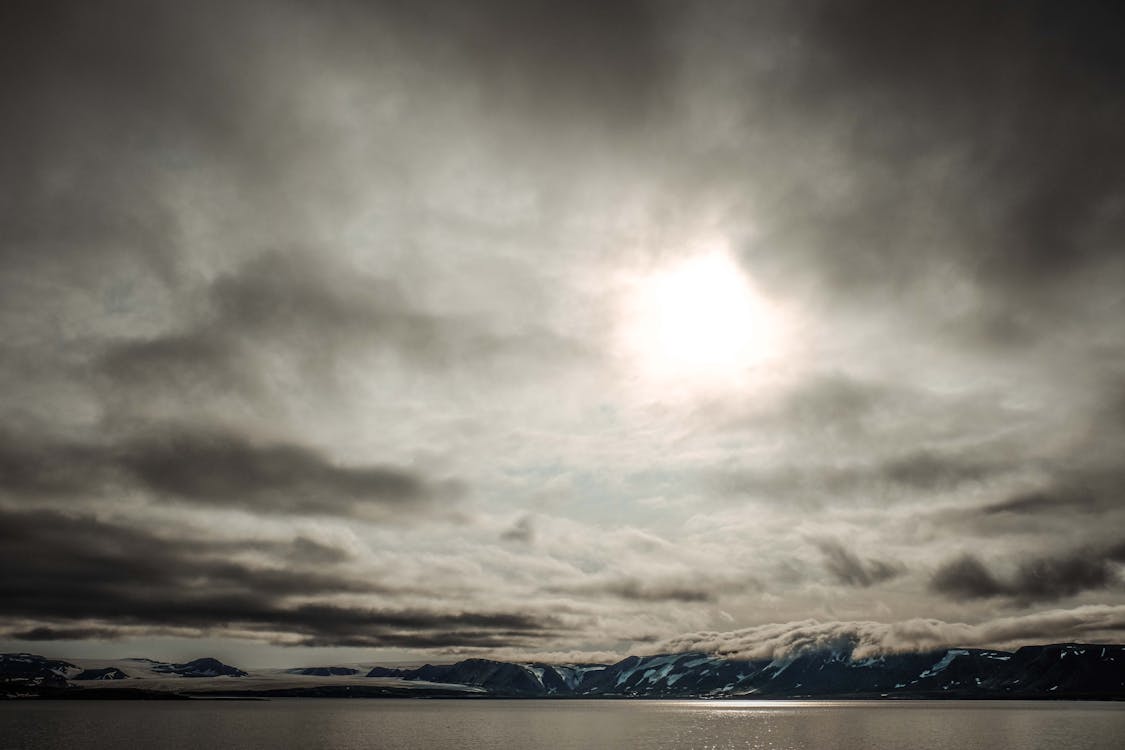 1125x750 Mysterious Arctic Landscape Under Cloudy Sky · Free