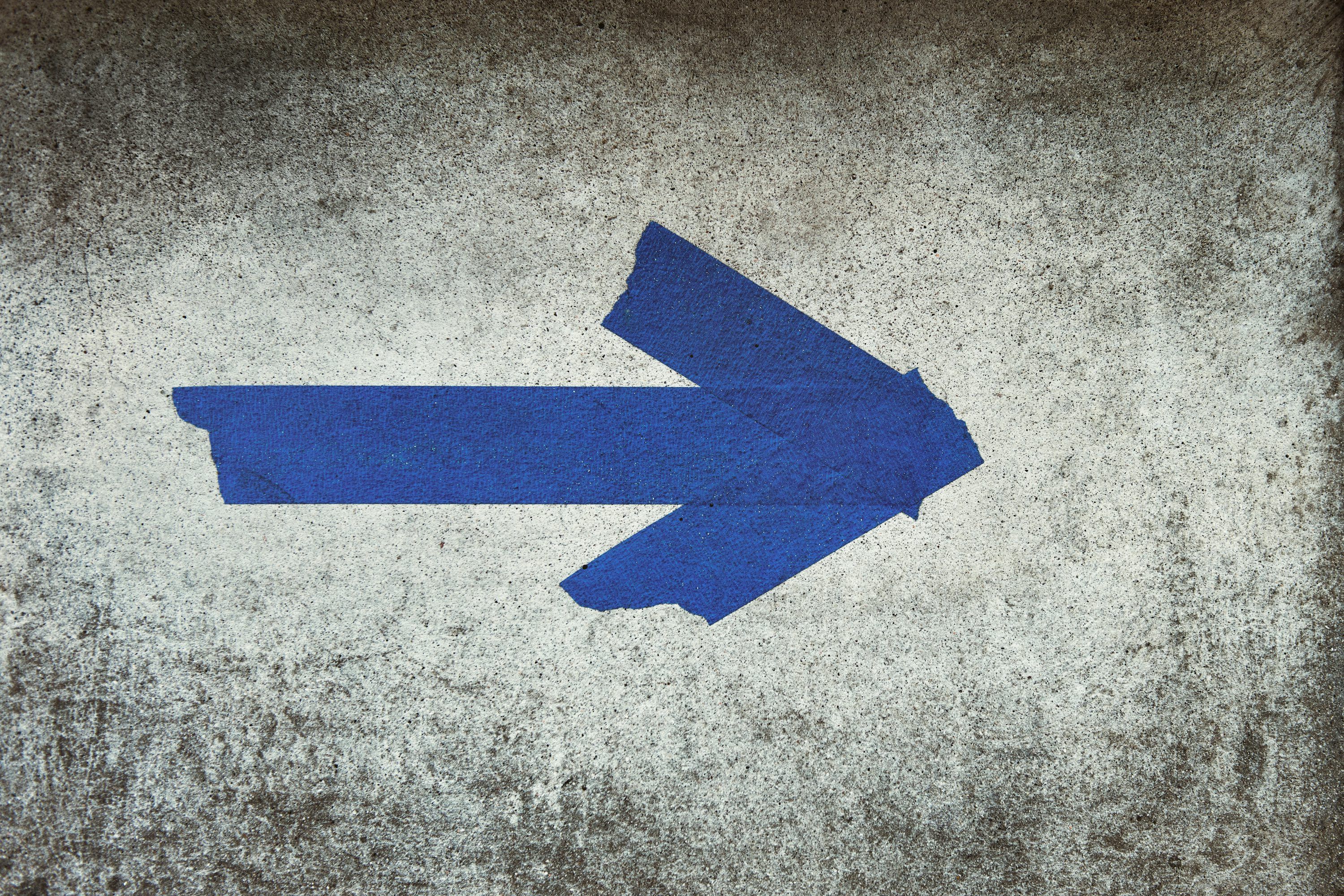 3000x2000 Blue arrow sign on gray textile photo