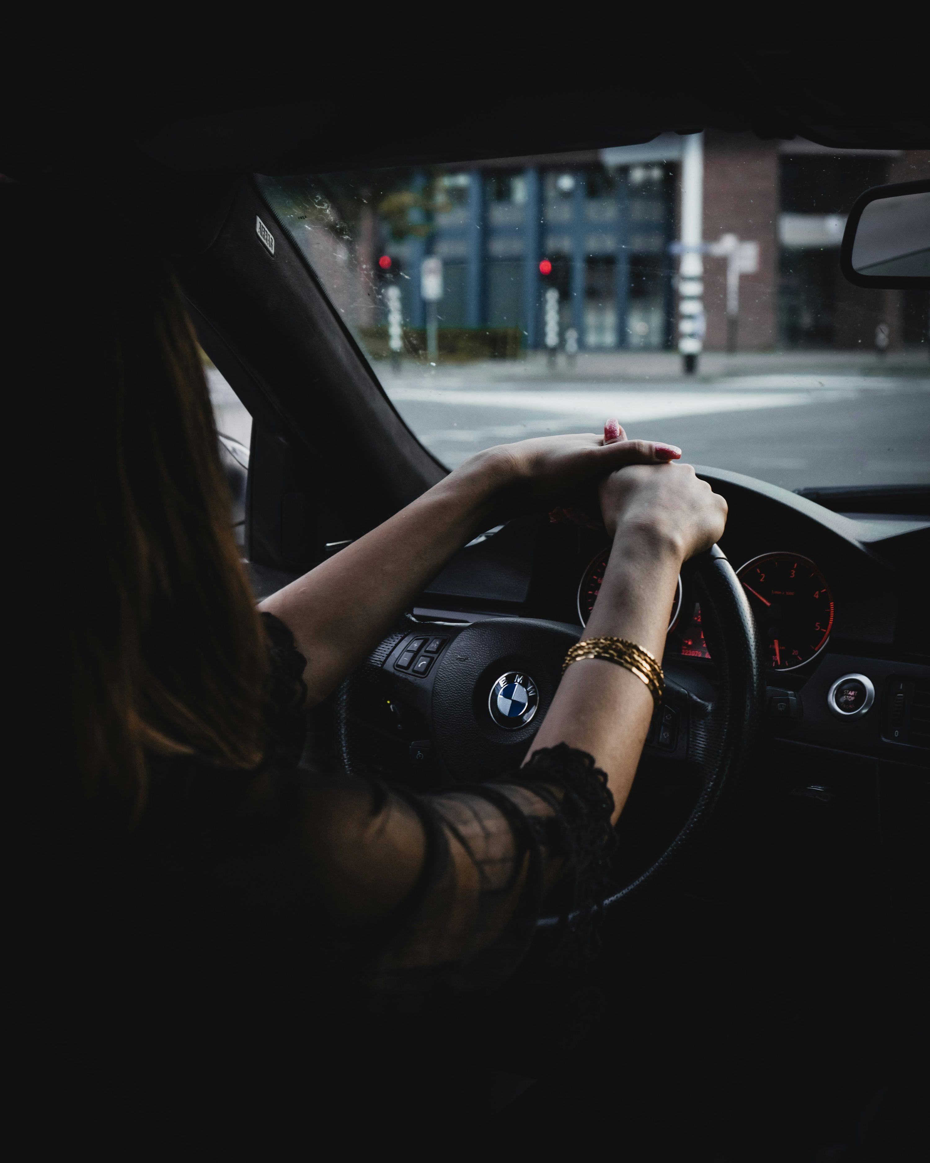 3000x3750 Woman inside BMW car holding steering wheel photo