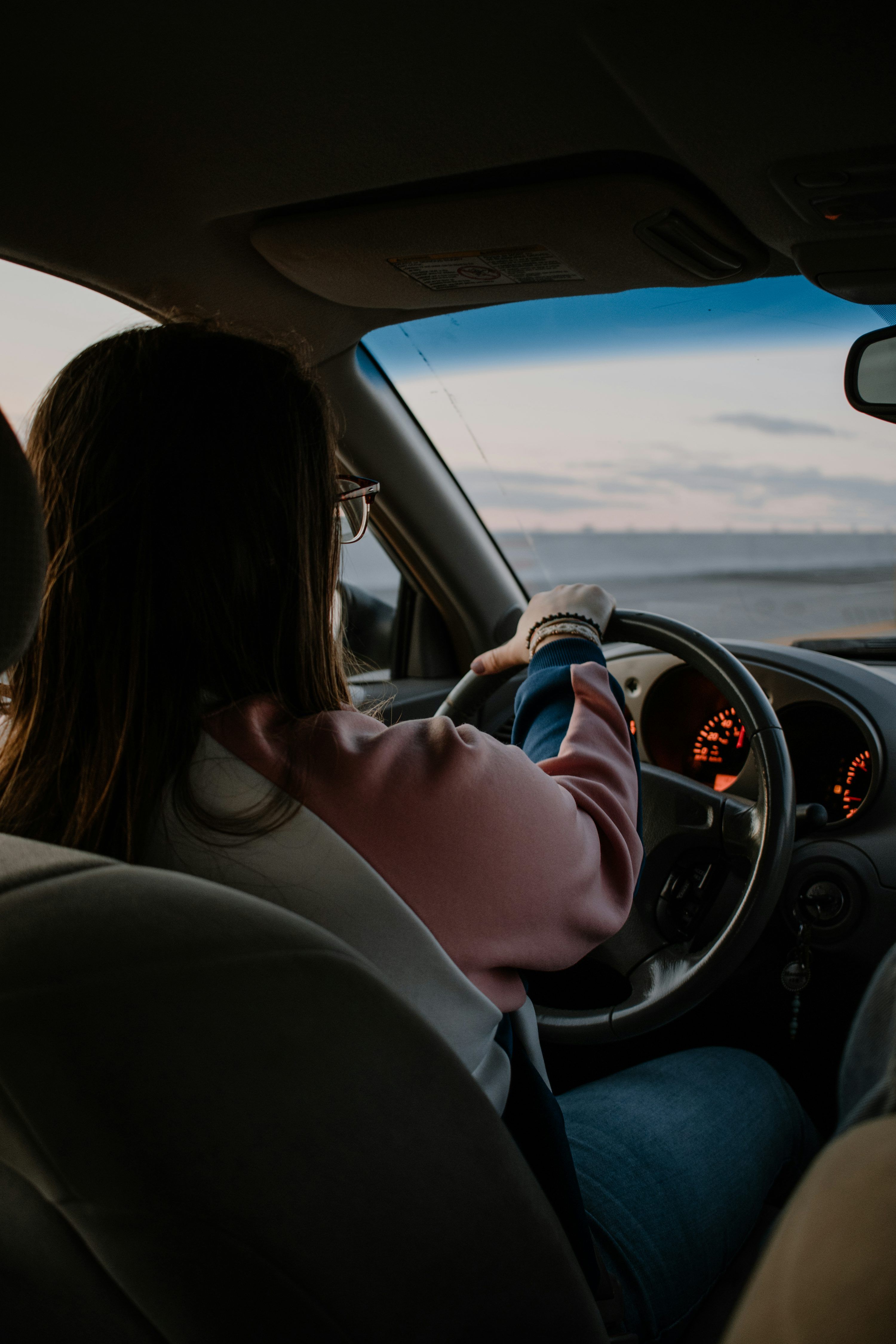 3000x4500 Woman in white long sleeve shirt driving car during daytime photo