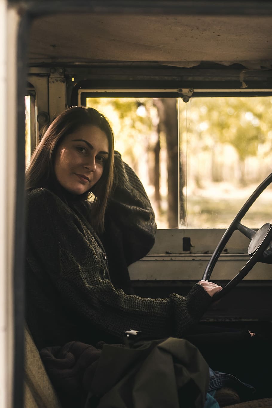910x1365 HD wallpaper: woman sitting inside vehicle holding steering wheel during daytime, woman holding steering wheel inside car