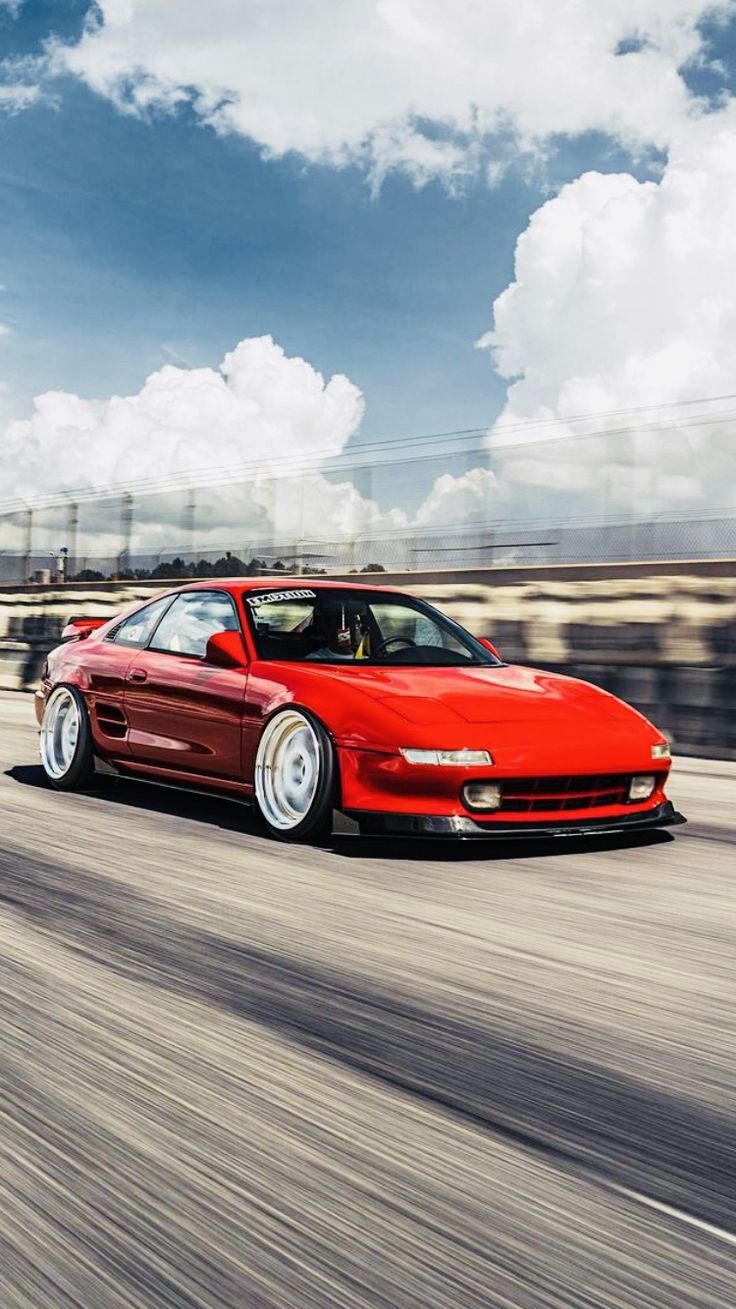 736x1309 Red Toyota MR2 Driving on a Sunny Day