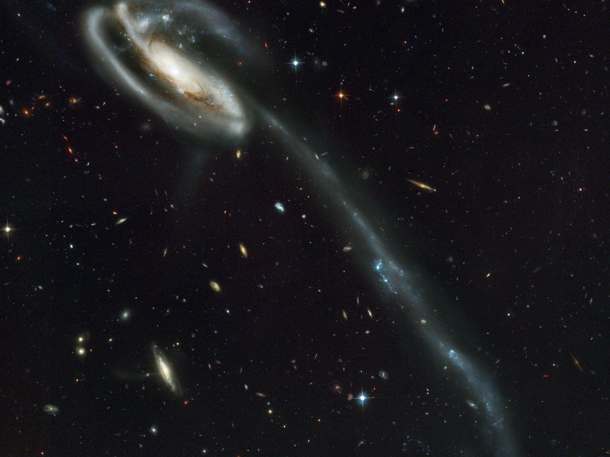 2048x1536 A 'wallpaper' Of Distant Galaxies Is A Stunning Backdrop For A Runaway Galaxy