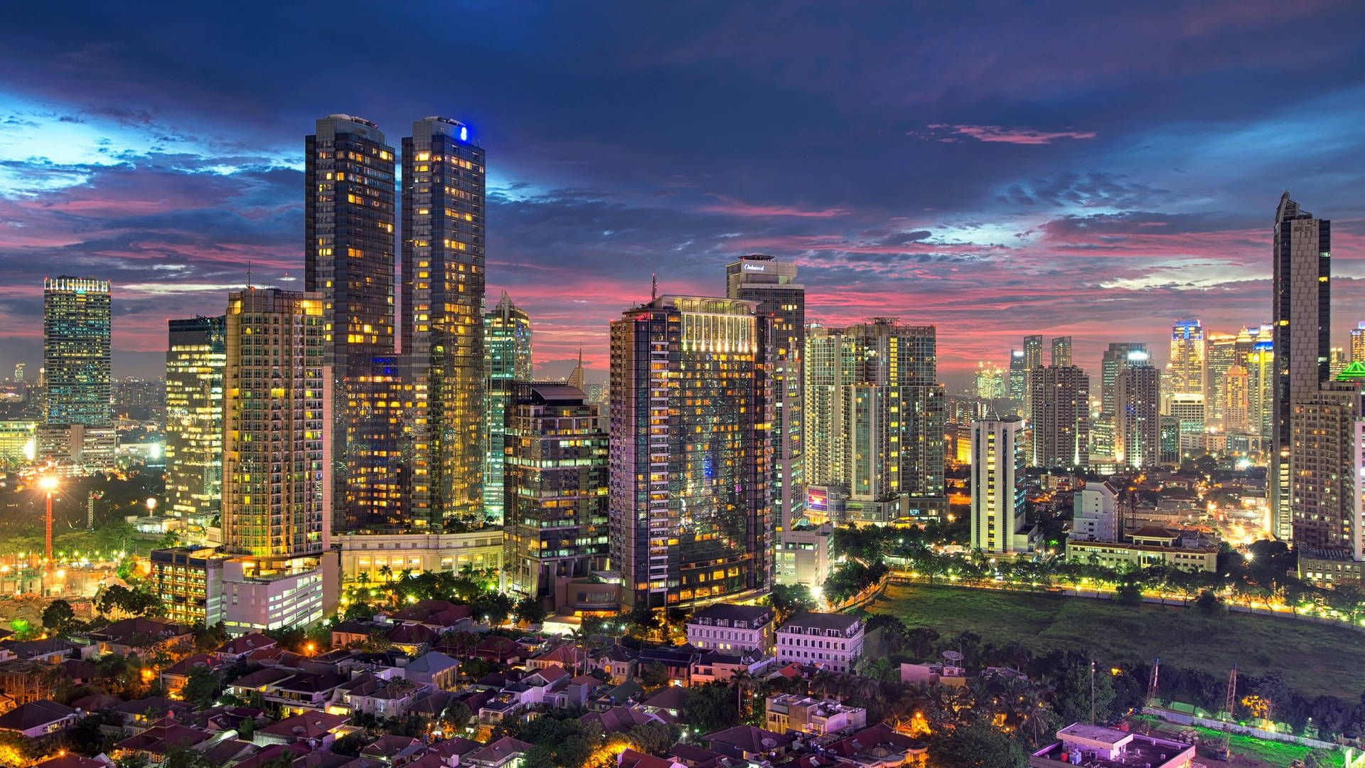 1920x1080 Download Vibrant Jakarta City Skyline Amidst Bustling Establishments Wallpaper