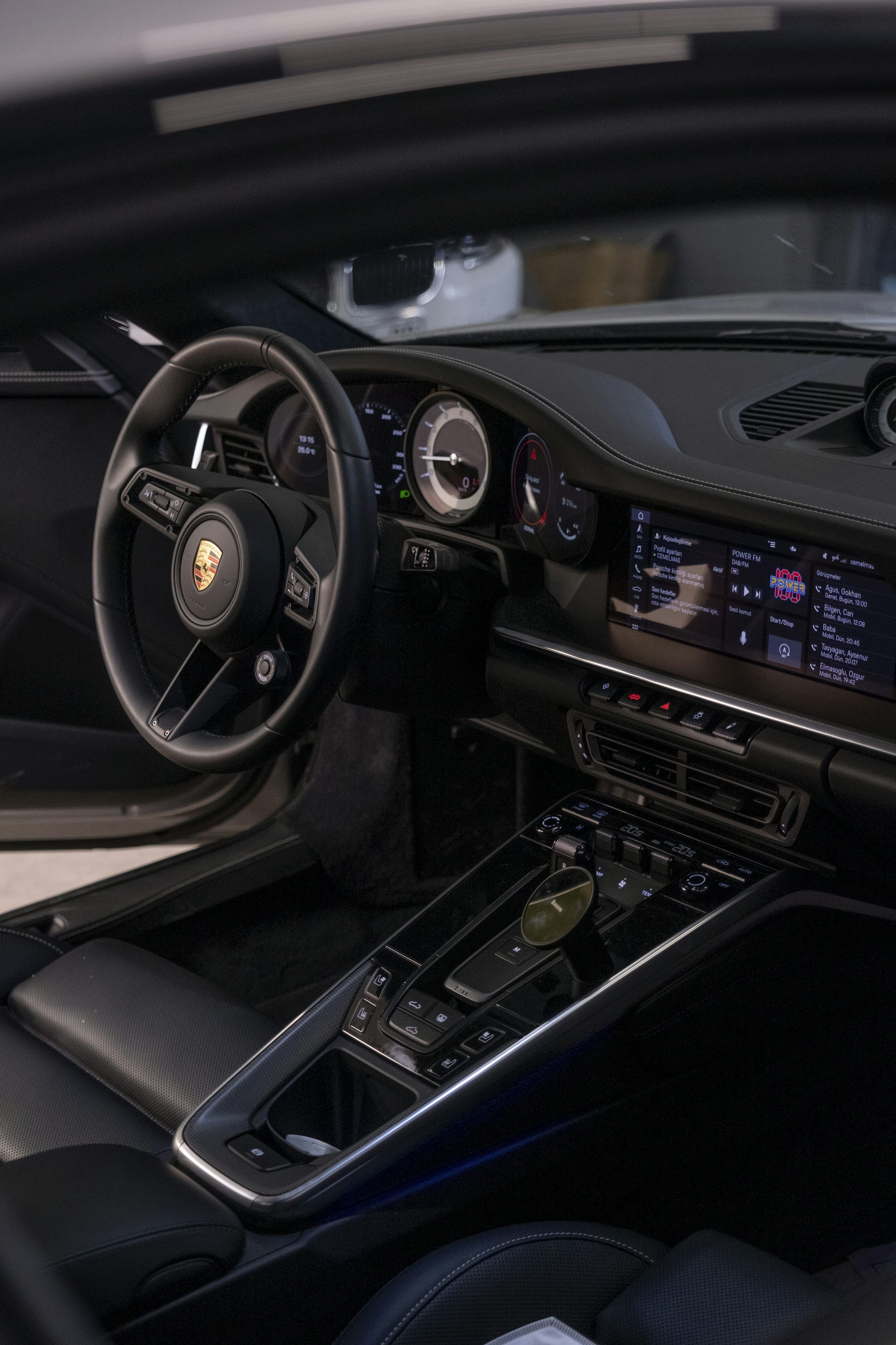 3000x4500 The interior of a car with a steering wheel and dashboard photo