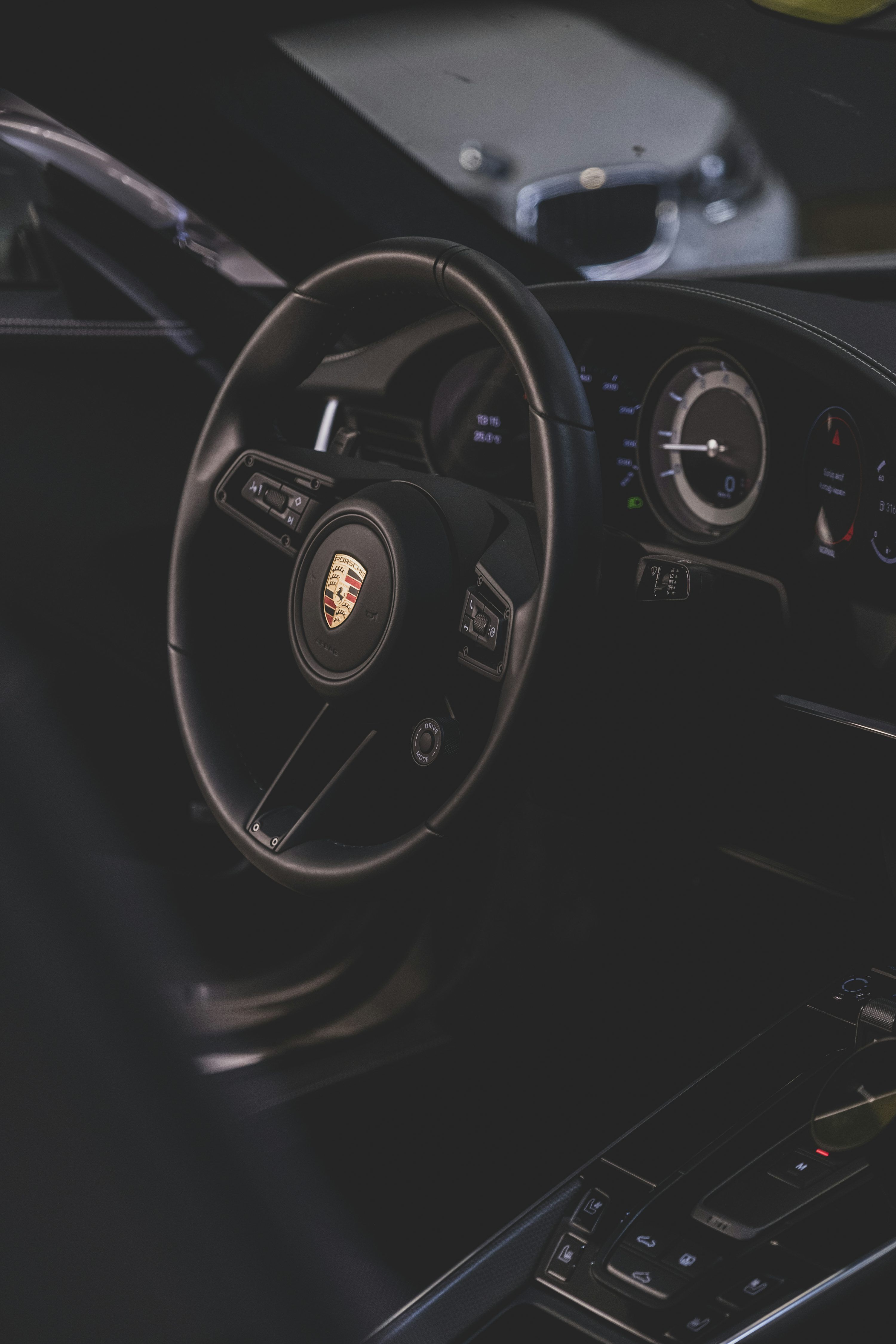 3000x4500 A steering wheel and dashboard of a car photo