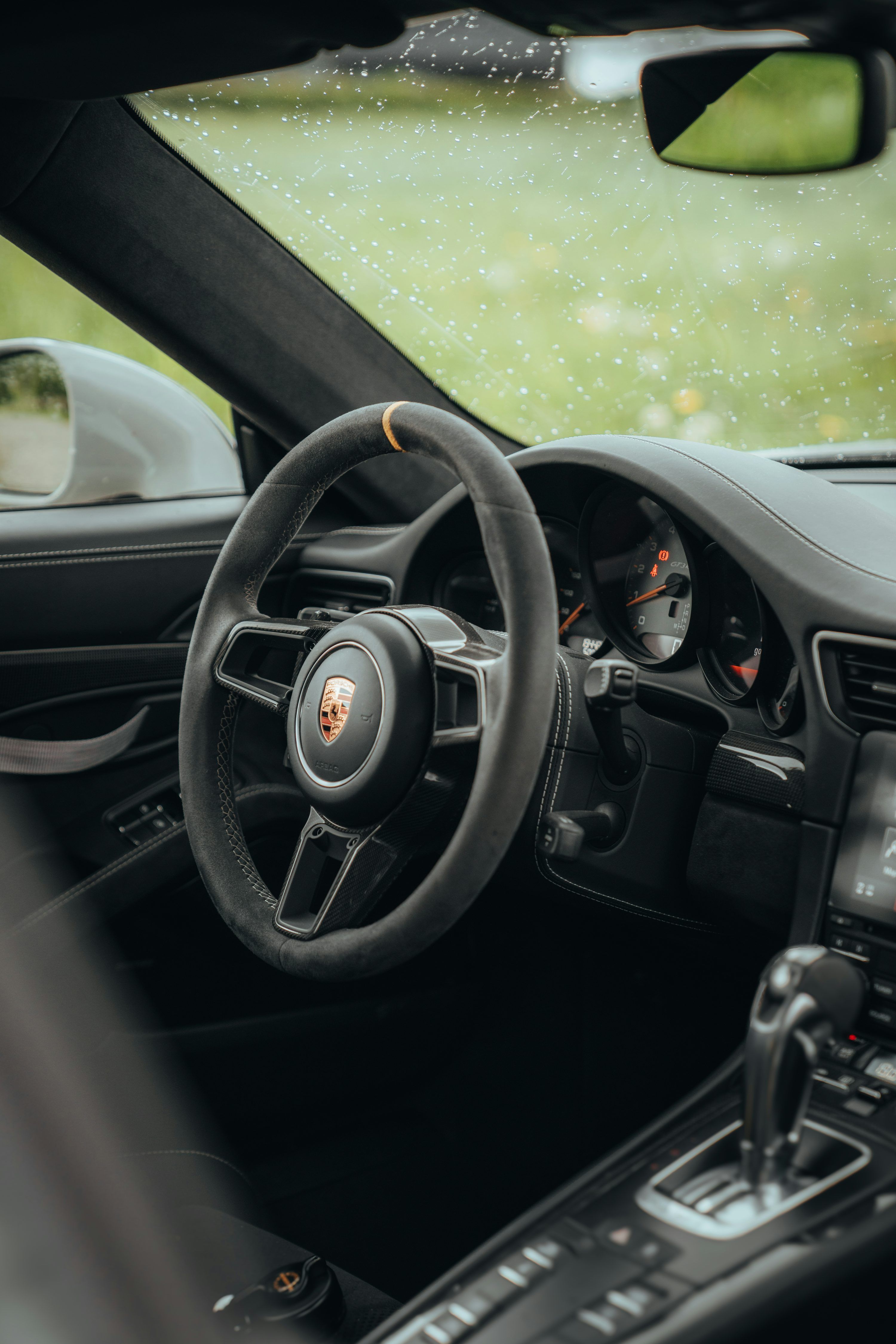 3000x4500 The interior of a car with a steering wheel and dashboard photo