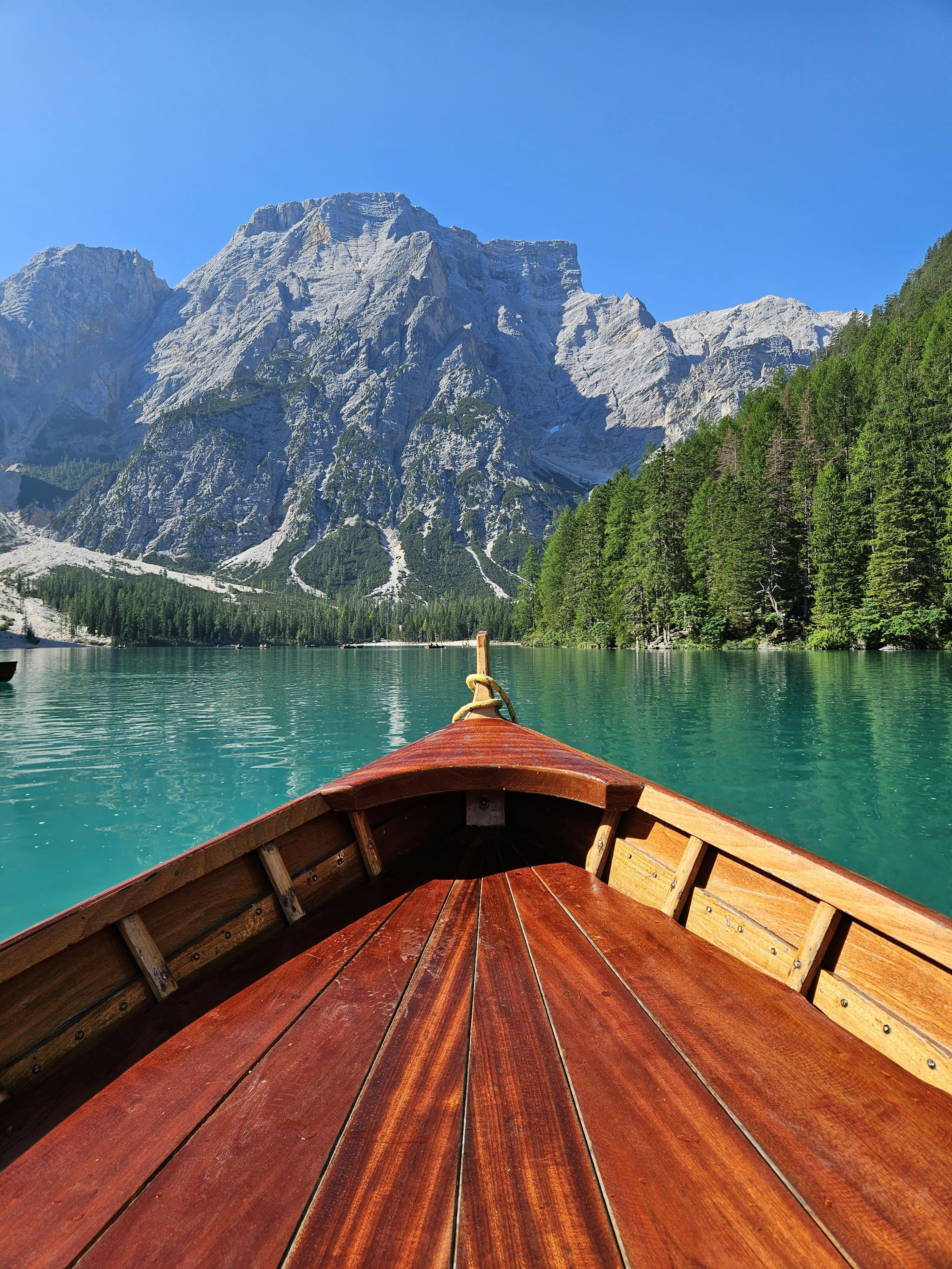 3000x4000 A boat traveling on a lake with mountains in the background photo