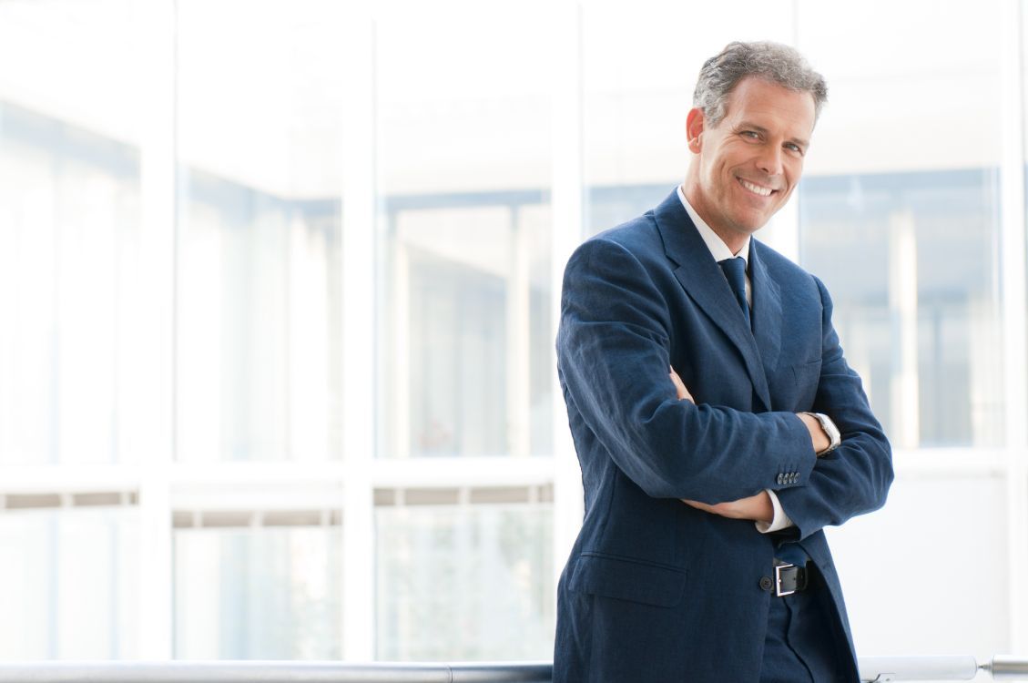 1129x750 Wallpaper Businessperson, Suit, Standing, Business, Formal Wear, Background Free Image