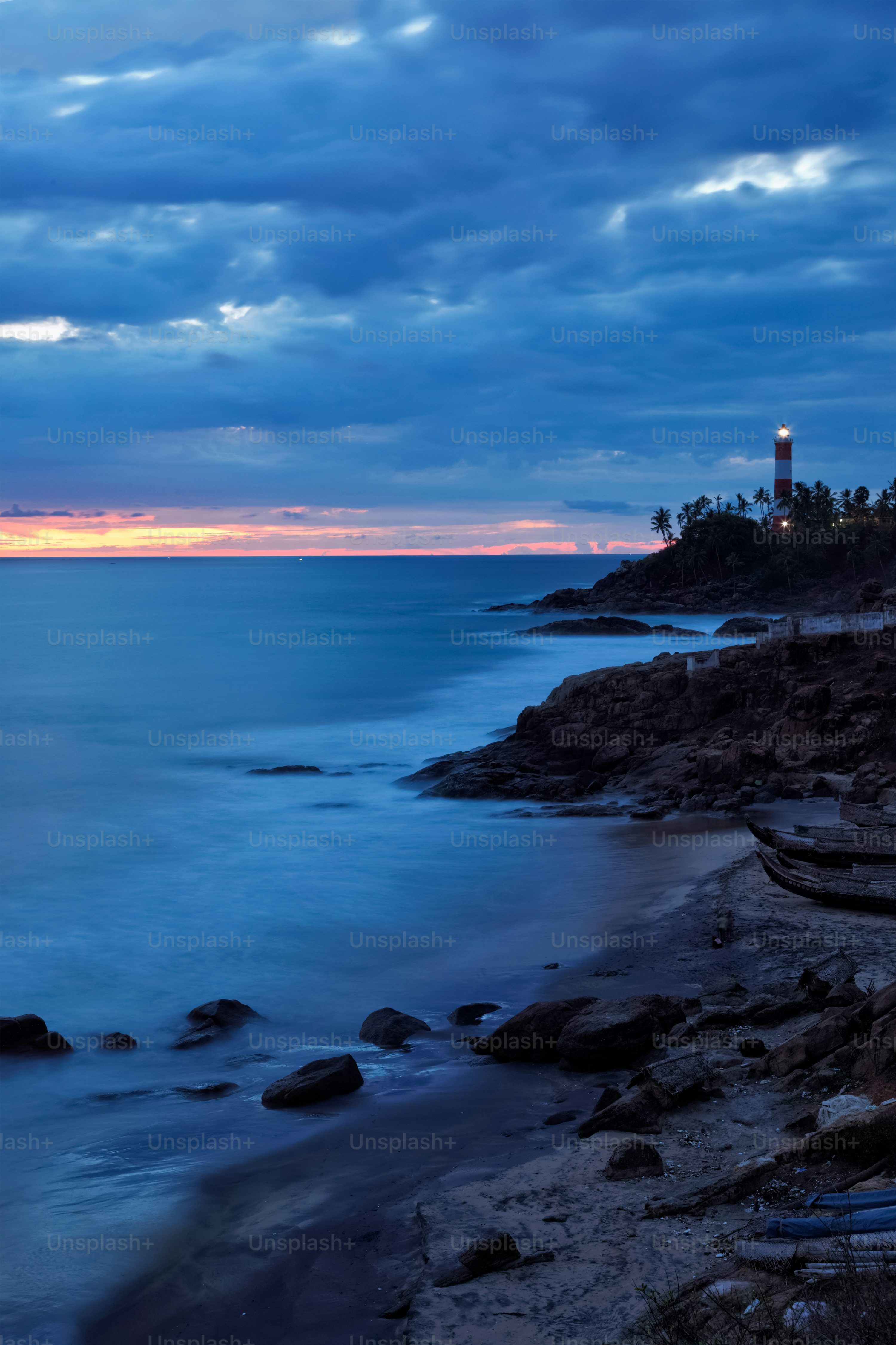 3000x4500 Kovalam Vizhinjam lighthouse on beautiful Arabian sea coast during sunset. Icredible India concept. Kerala, India photo