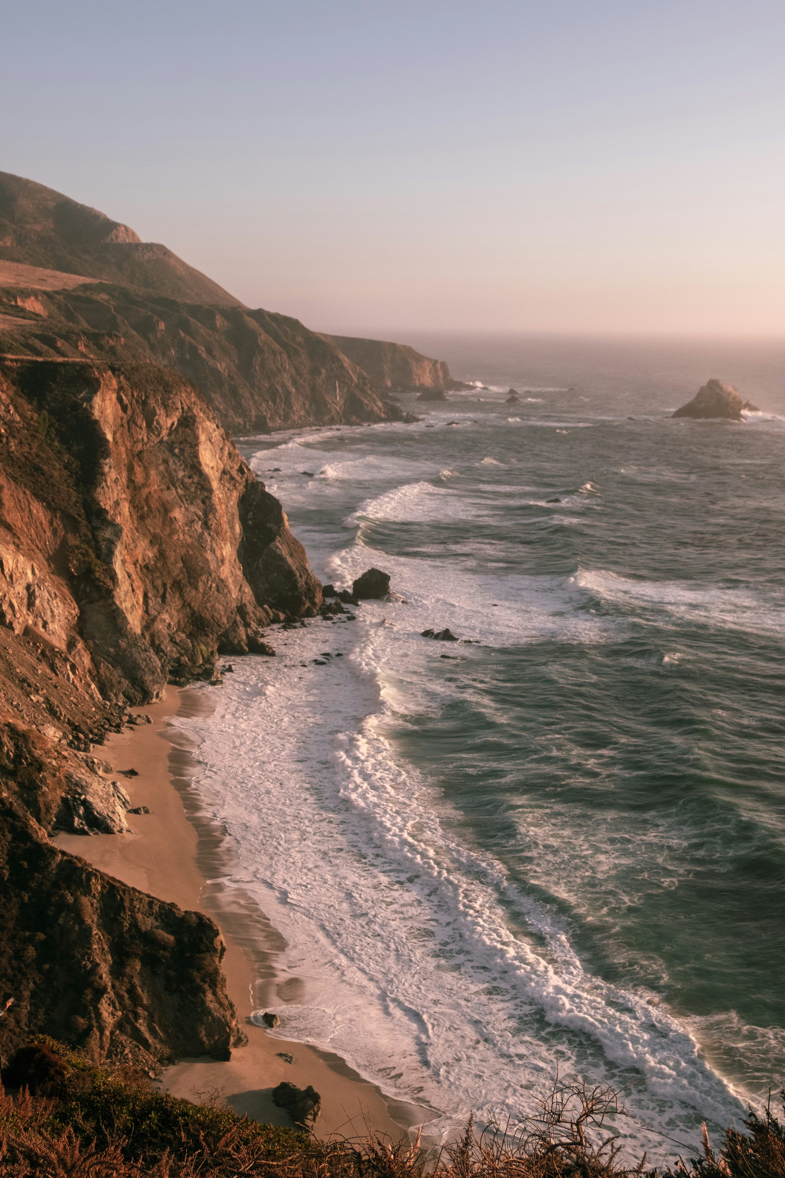3000x4500 A view of the ocean from the top of a hill photo