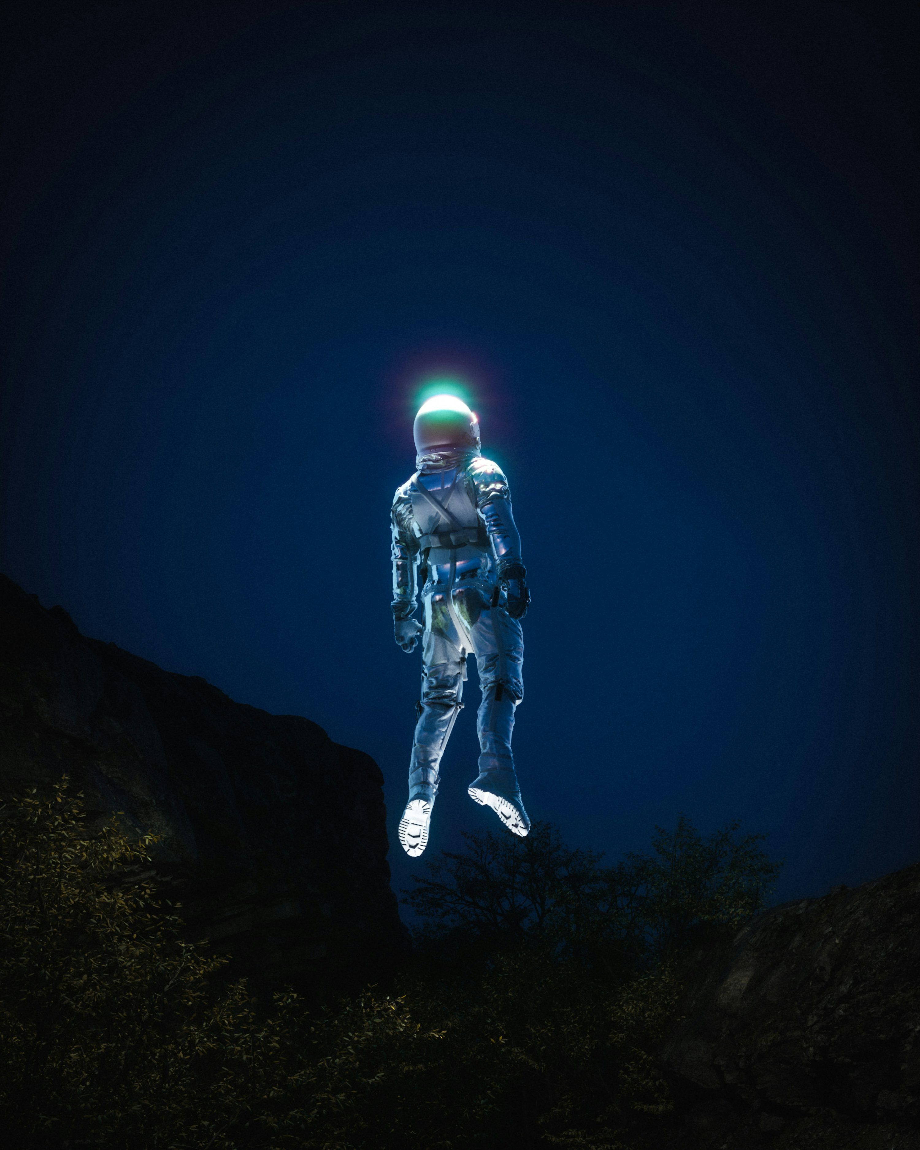 3000x3750 A man in a space suit standing on top of a hill photo