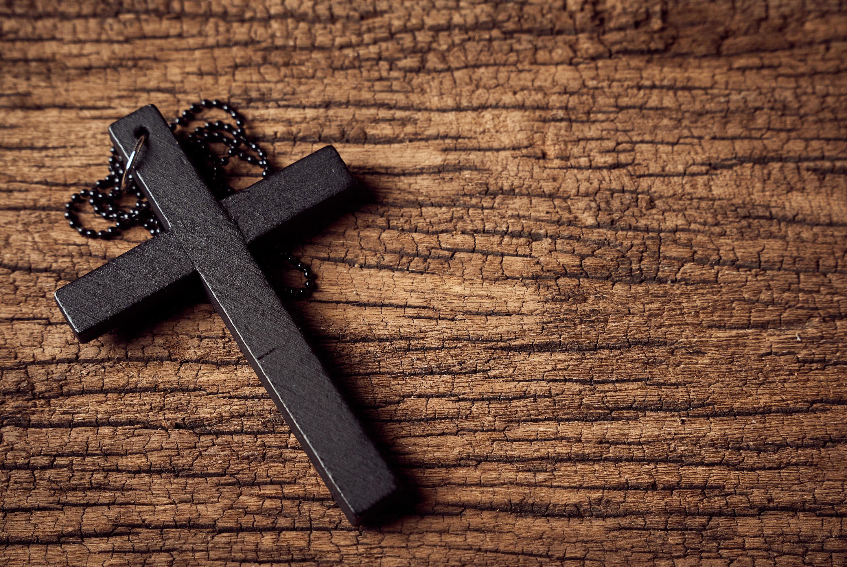 2928x1960 Concept of Christian. close up Jesus Christ black cross on the old wooden table background with copy space