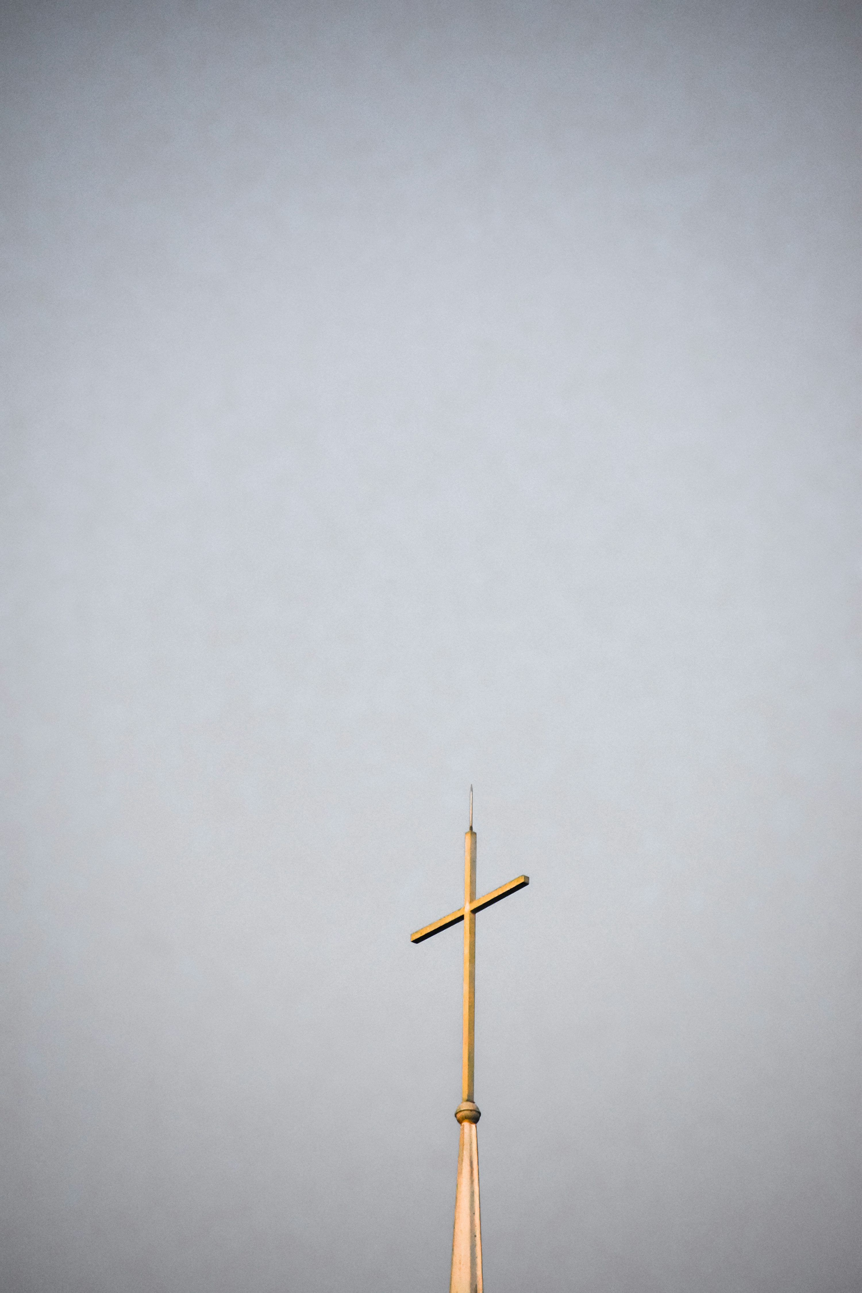 3000x4500 A tall wooden cross on top of a building photo