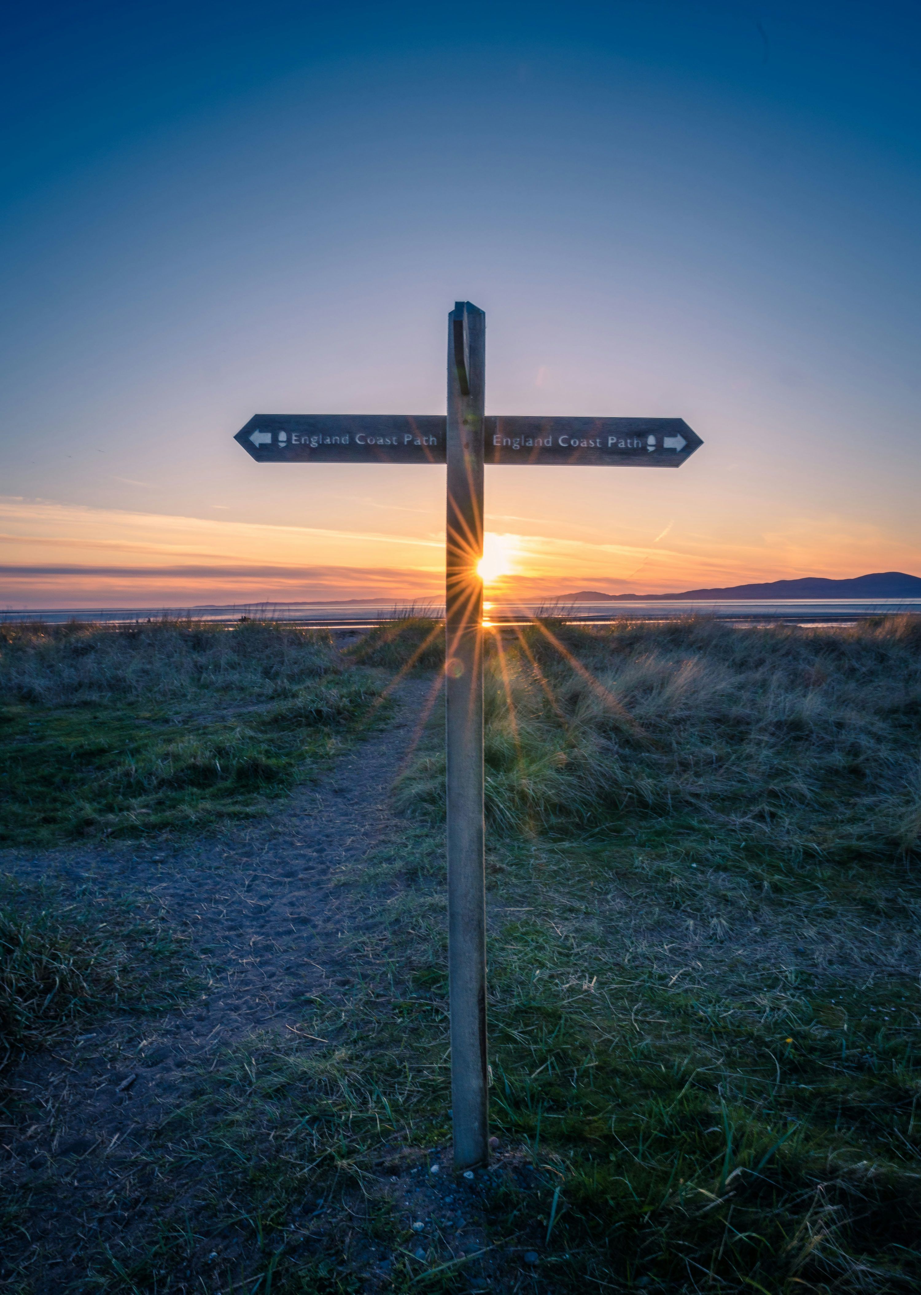 3000x4215 A wooden cross with a sunset in the background photo