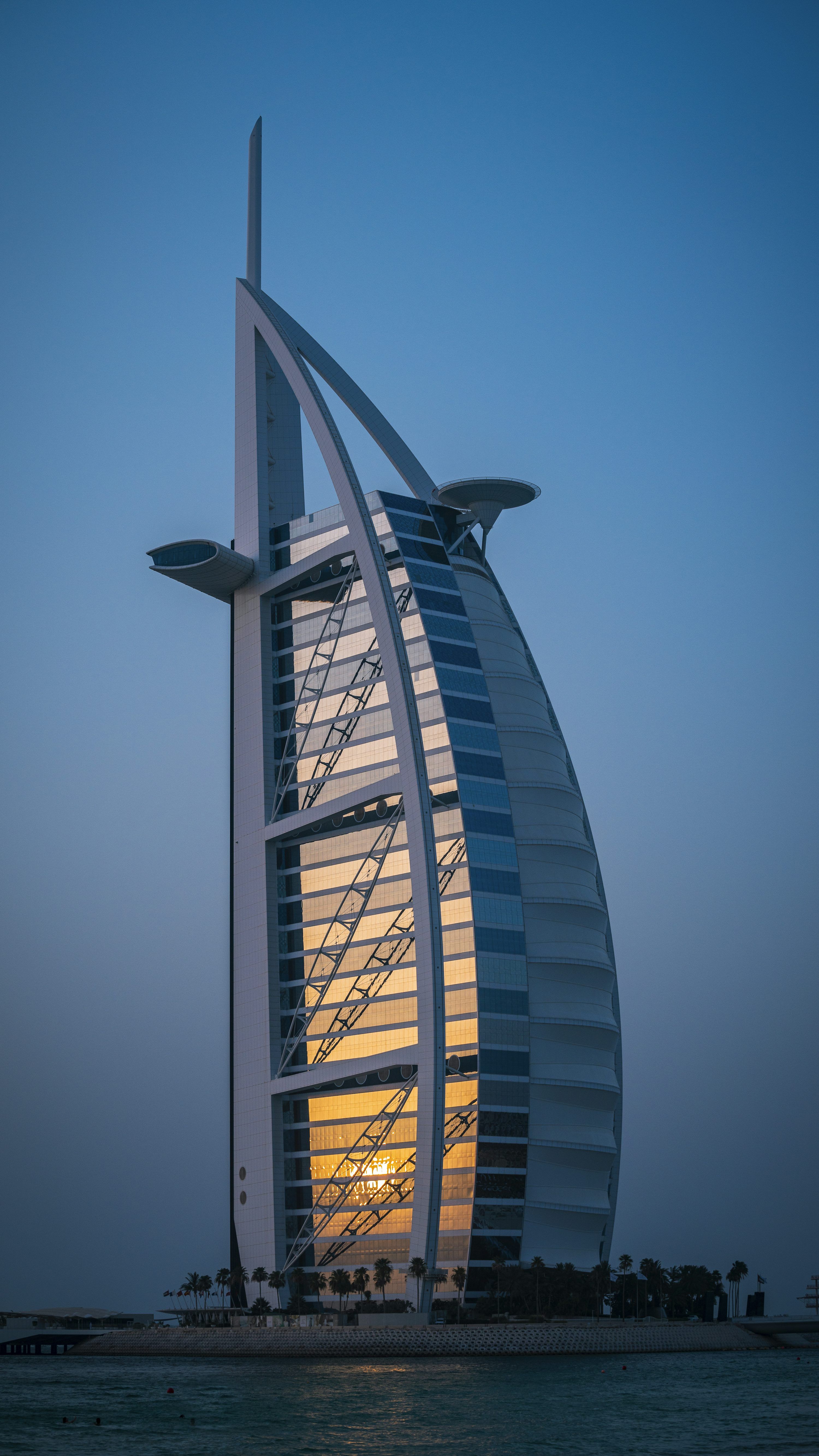 3000x5333 Burj al arab reflecting the sunset over the water. photo