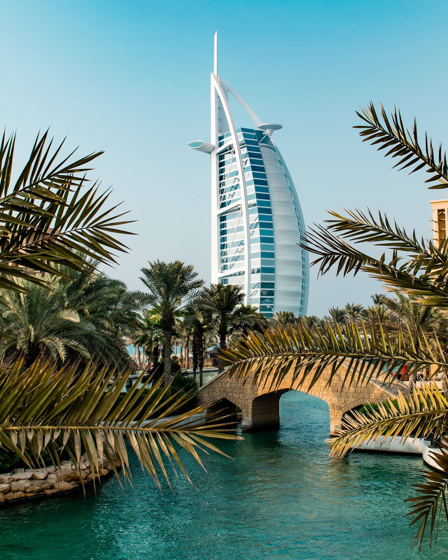 1536x1920 Download Majestic view of the iconic Burj Al Arab in Dubai at sunset Wallpaper
