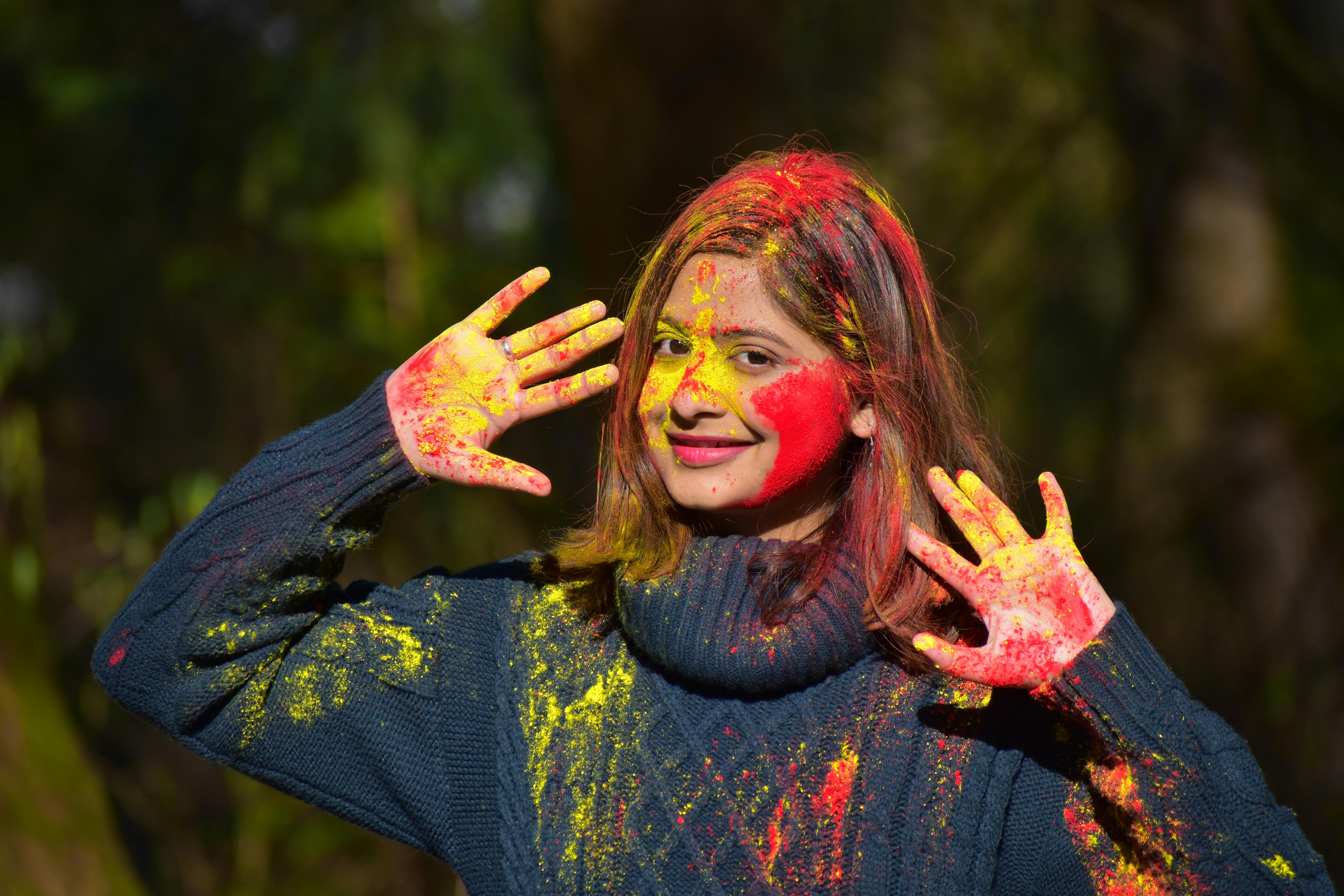 6000x4000 Woman In Blue Long Sleeve Shirt With Red And Yellow Powder On Her Face · Free