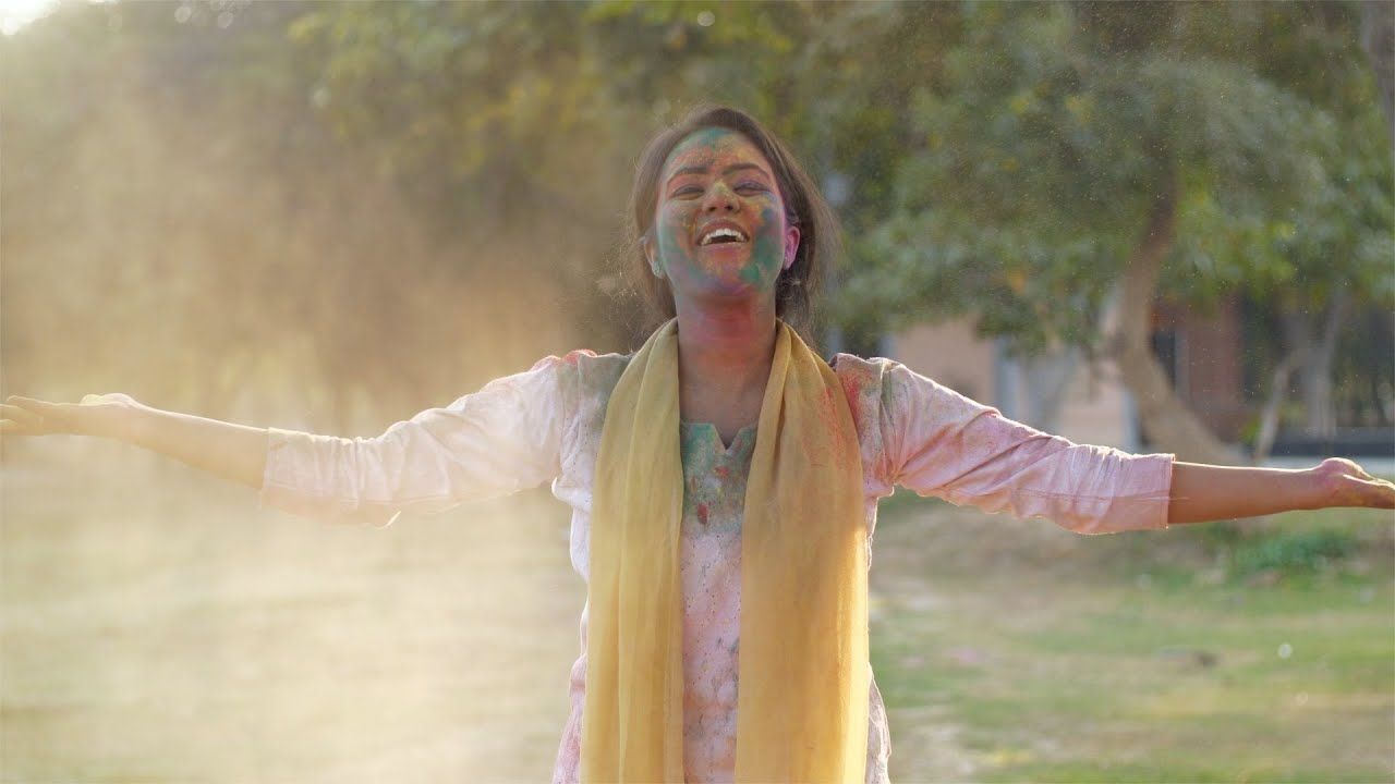 1280x720 Young Female Blowing Colorful Gulal Off Her Hands Stock Video