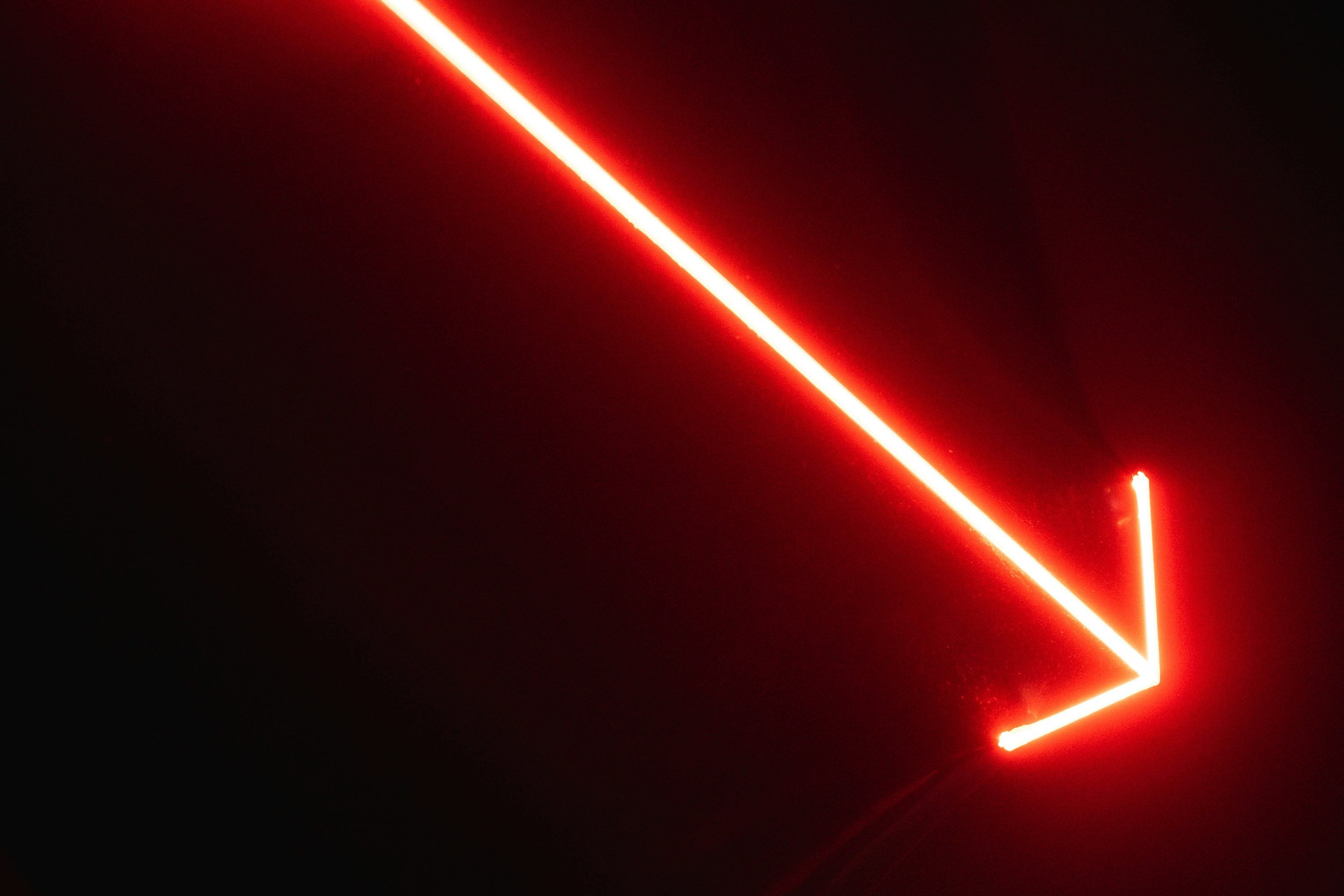 3000x2000 A red neon arrow pointing upward in the dark photo