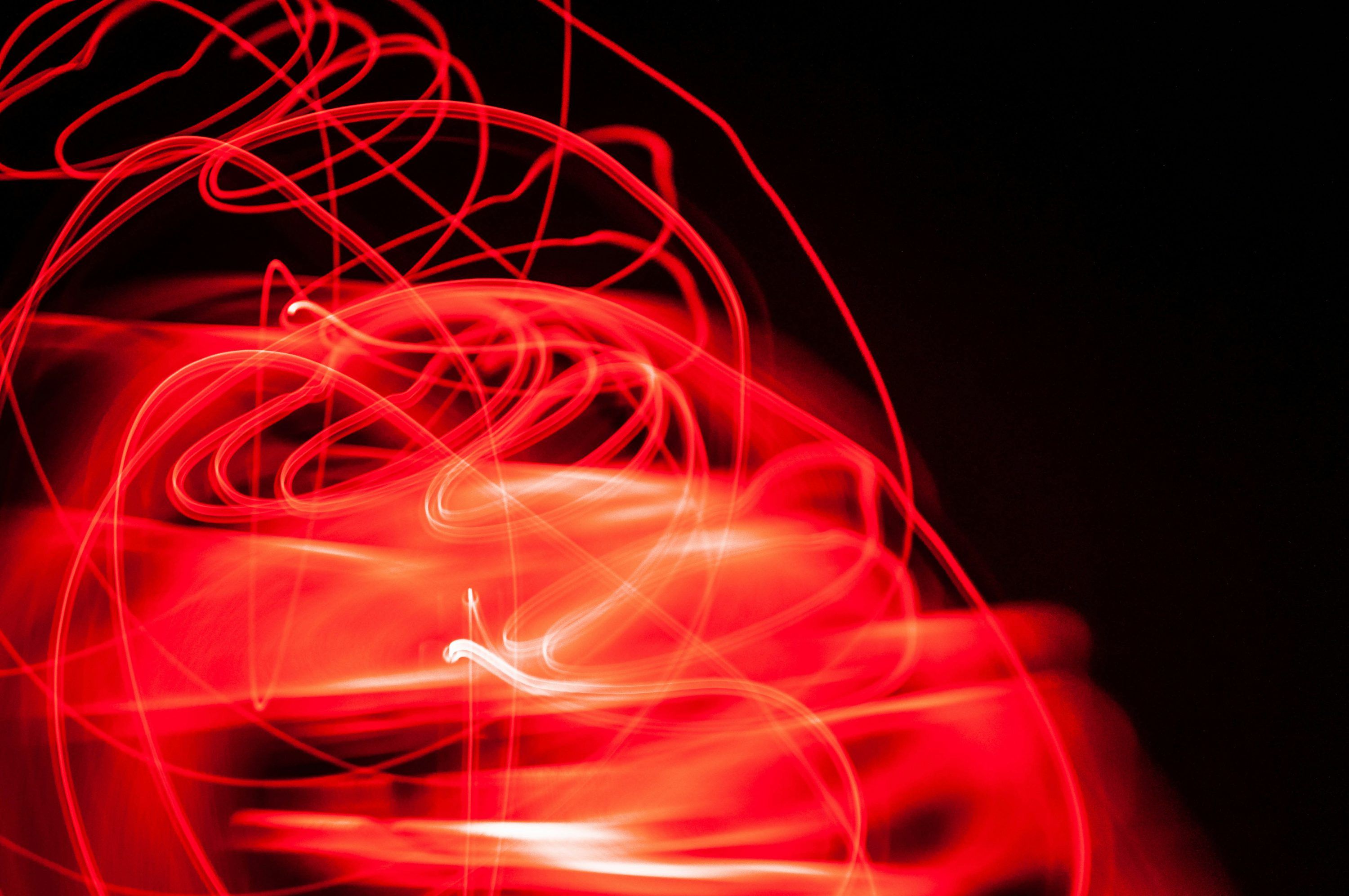 3000x1993 A blurry photo of a red object in the dark photo