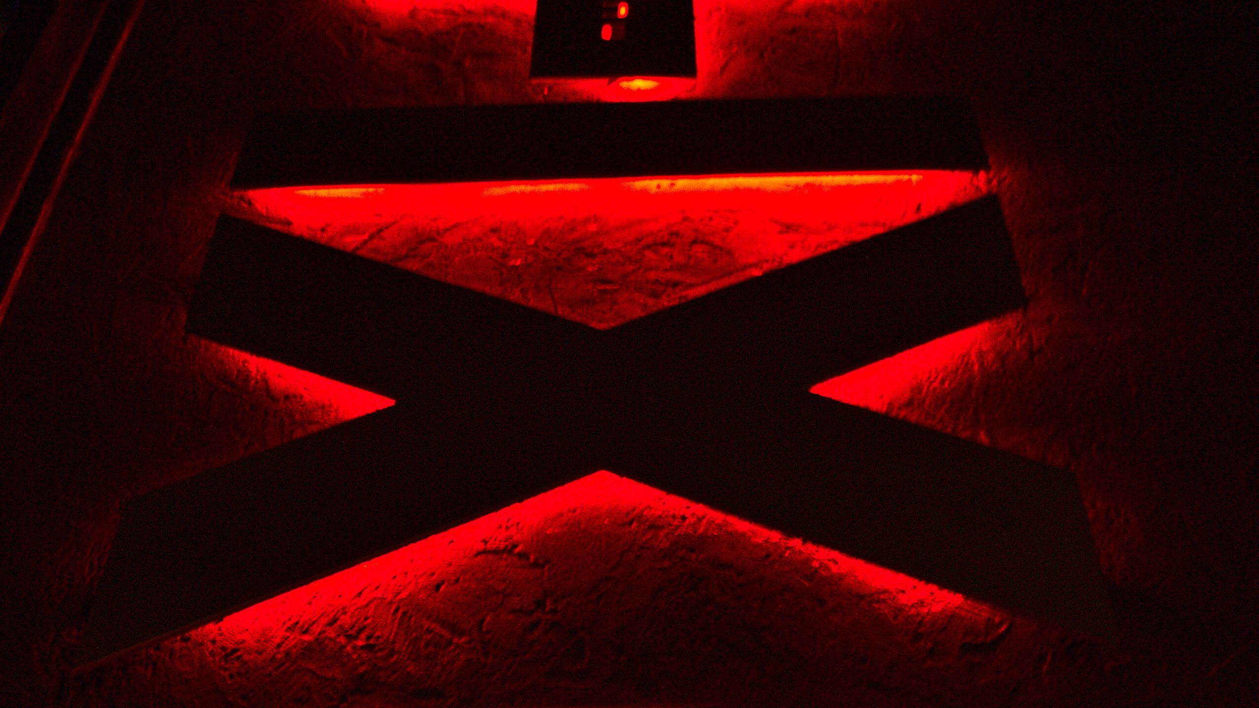 2560x1440 Download wallpaper 2560x1440 symbols, neon, red, backlight, dark widescreen 16:9 HD background