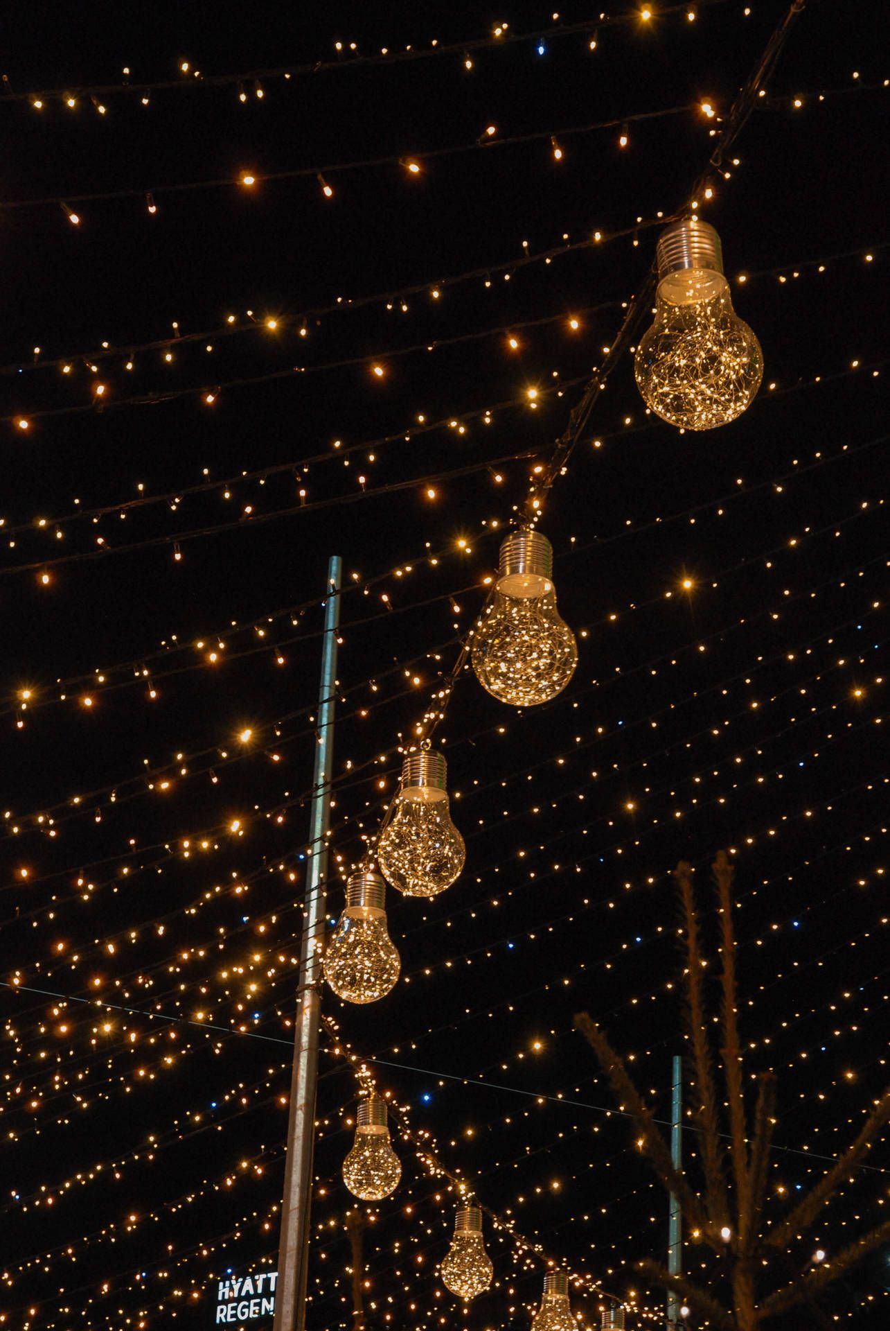1285x1920 Download A Street With Lights And A Christmas Tree Wallpaper
