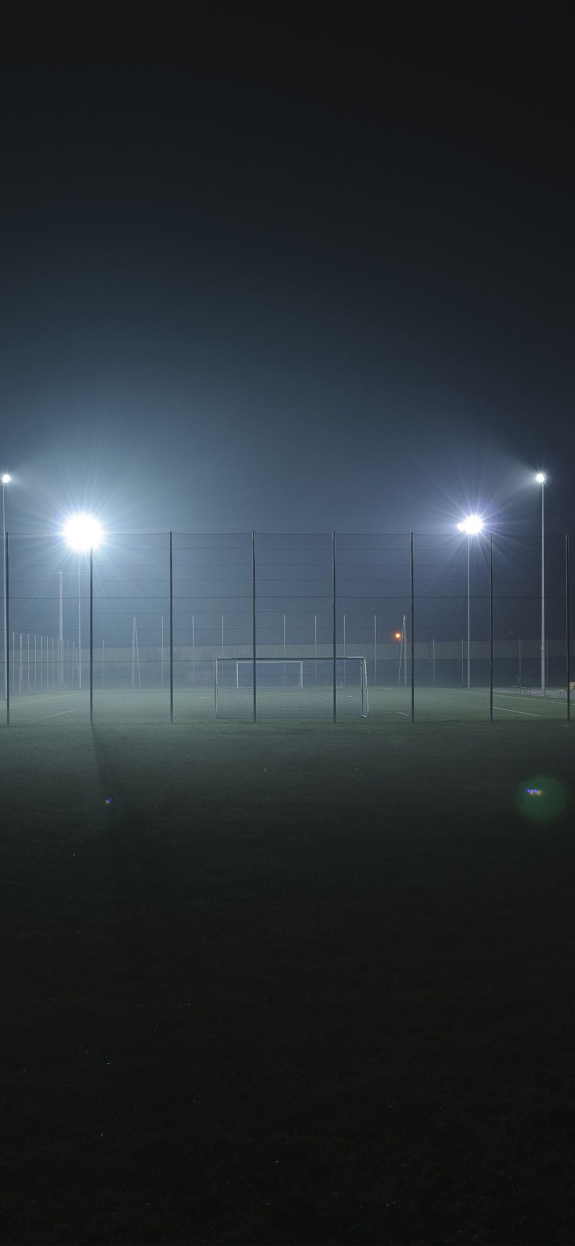 1125x2436 iPhone X wallpaper. soccer field city night light dark