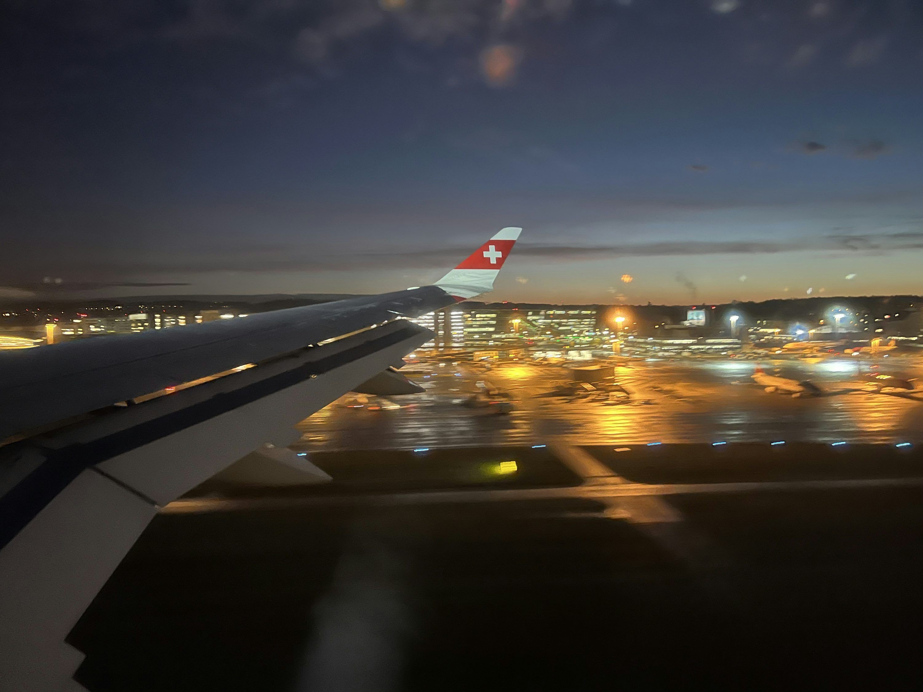 3000x2250 A view of an airport at night from an airplane window photo