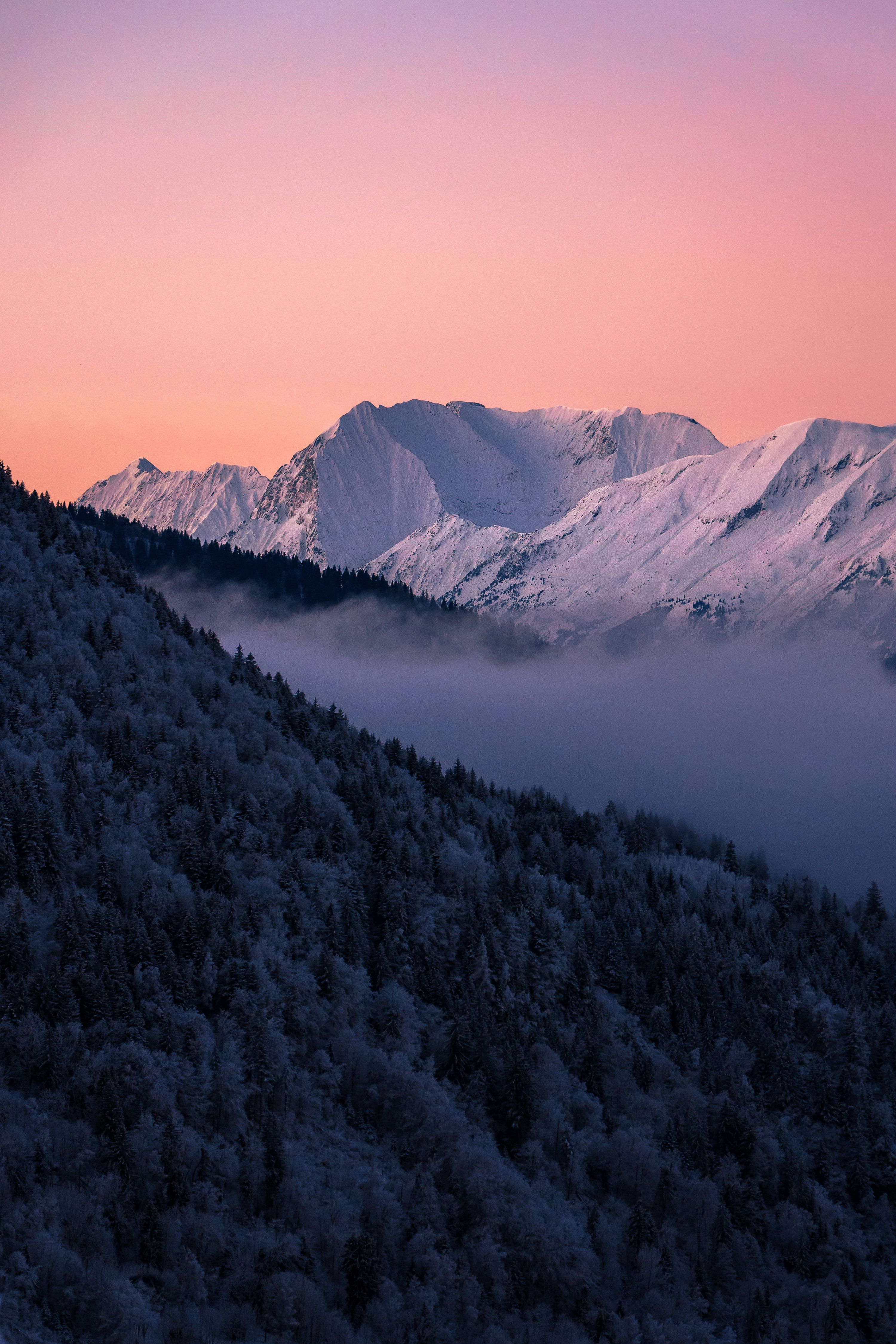 3000x4500 A mountain covered in snow with a pink sky photo