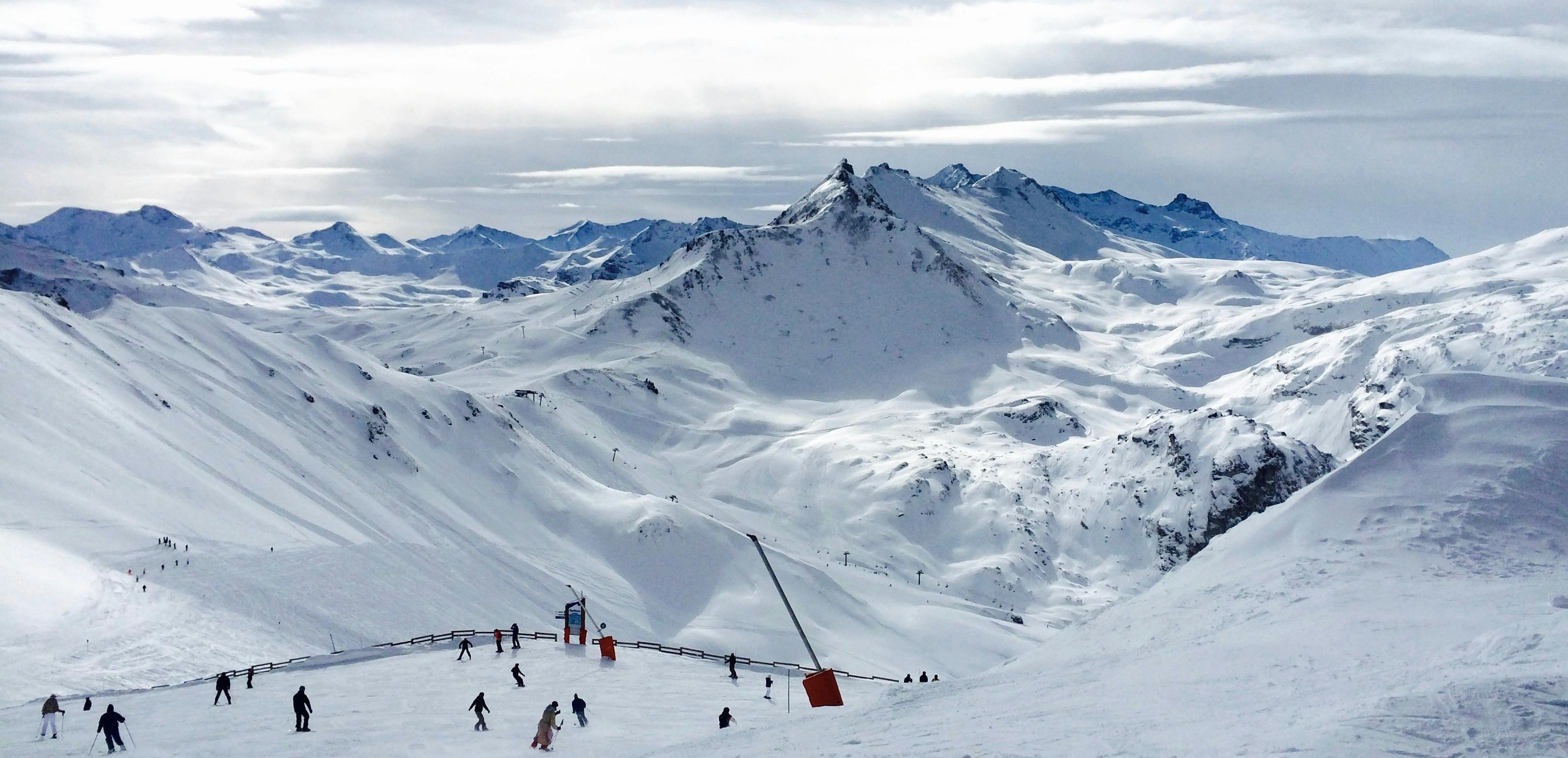 3084x1491 People Lurking Around on Snow Field Near Mountains · Free