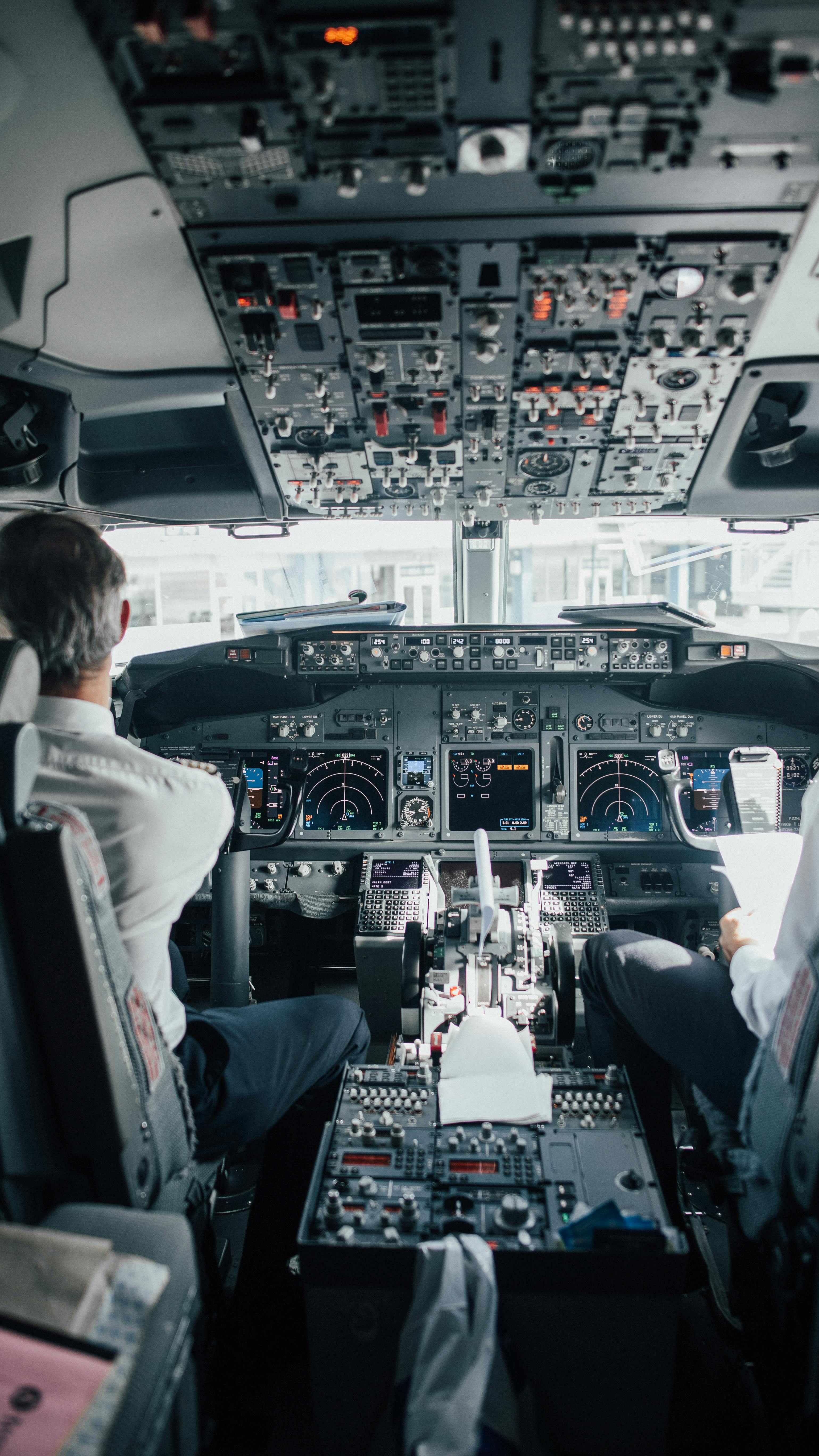 3078x5472 Man Sitting Inside a Cockpit of an Airplane · Free