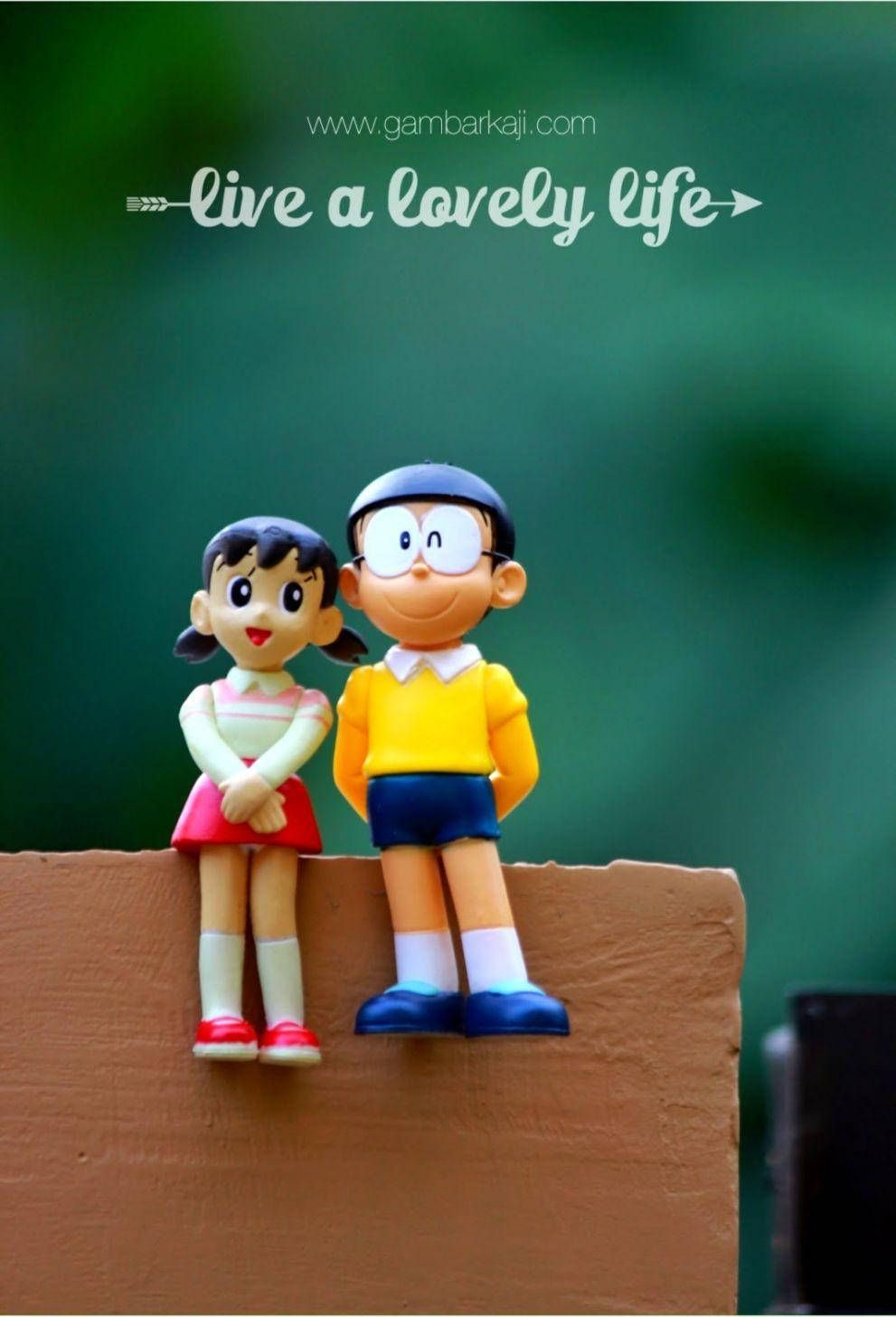 991x1456 Download Nobita Shizuka Love Figurine Toys Sitting Wallpaper