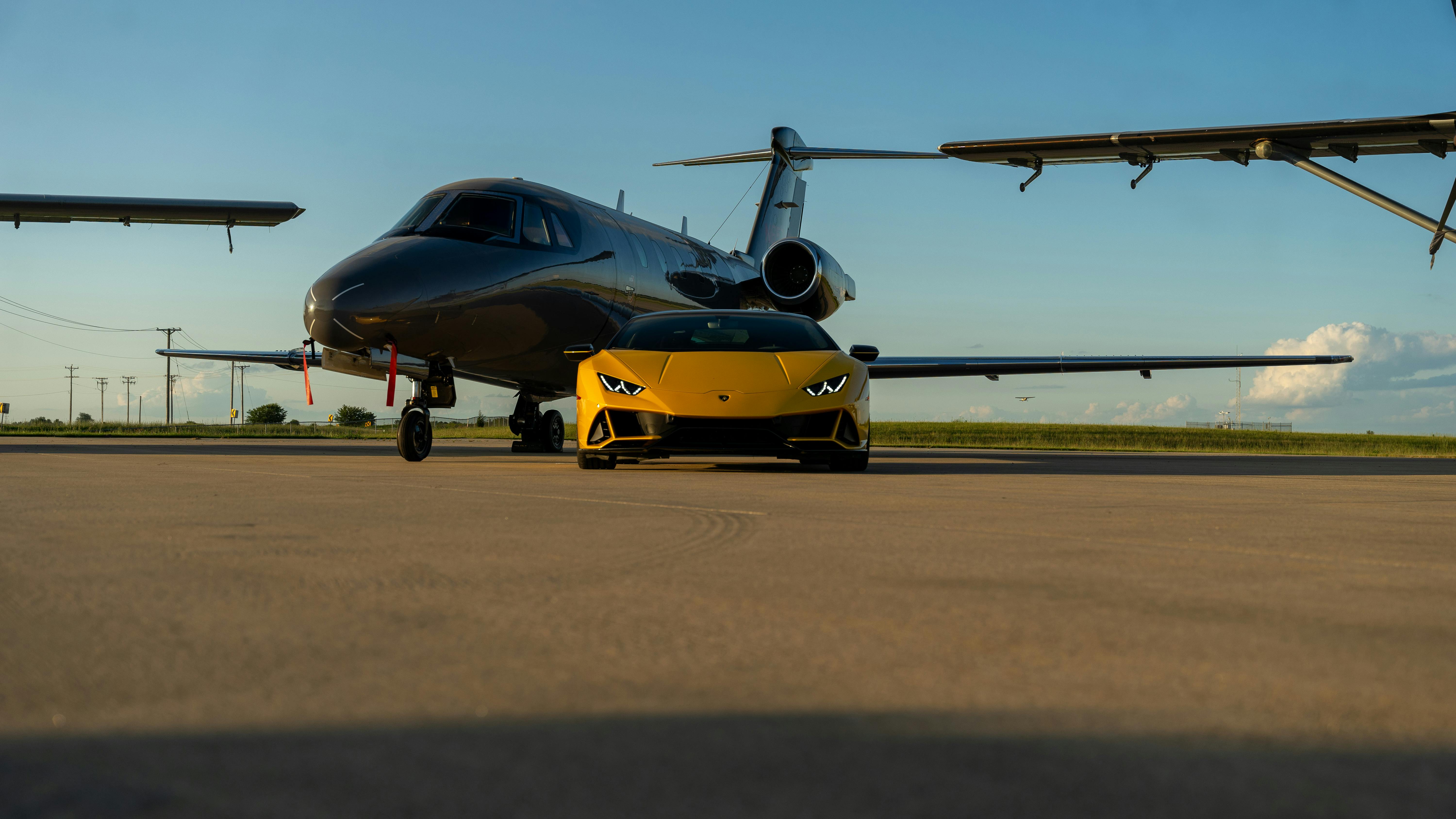 6000x3376 Luxury Sports Car and Private Jet on Tarmac · Free