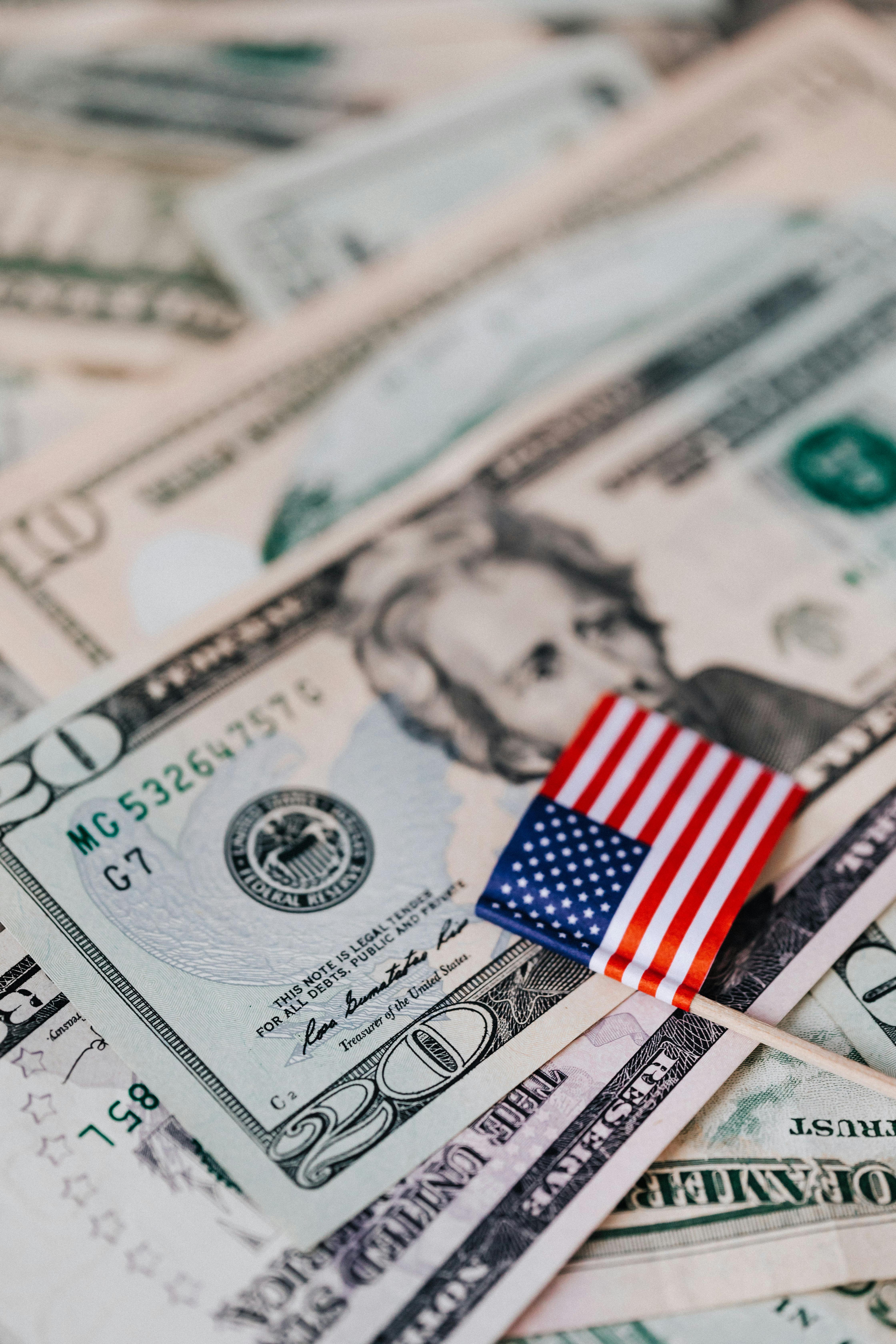 4480x6720 Stack of USA money and national flag · Free