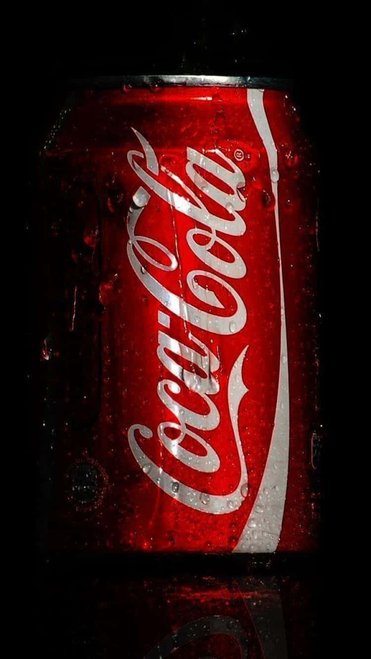 750x1334 Download Coca Cola Can On A Black Background Wallpaper