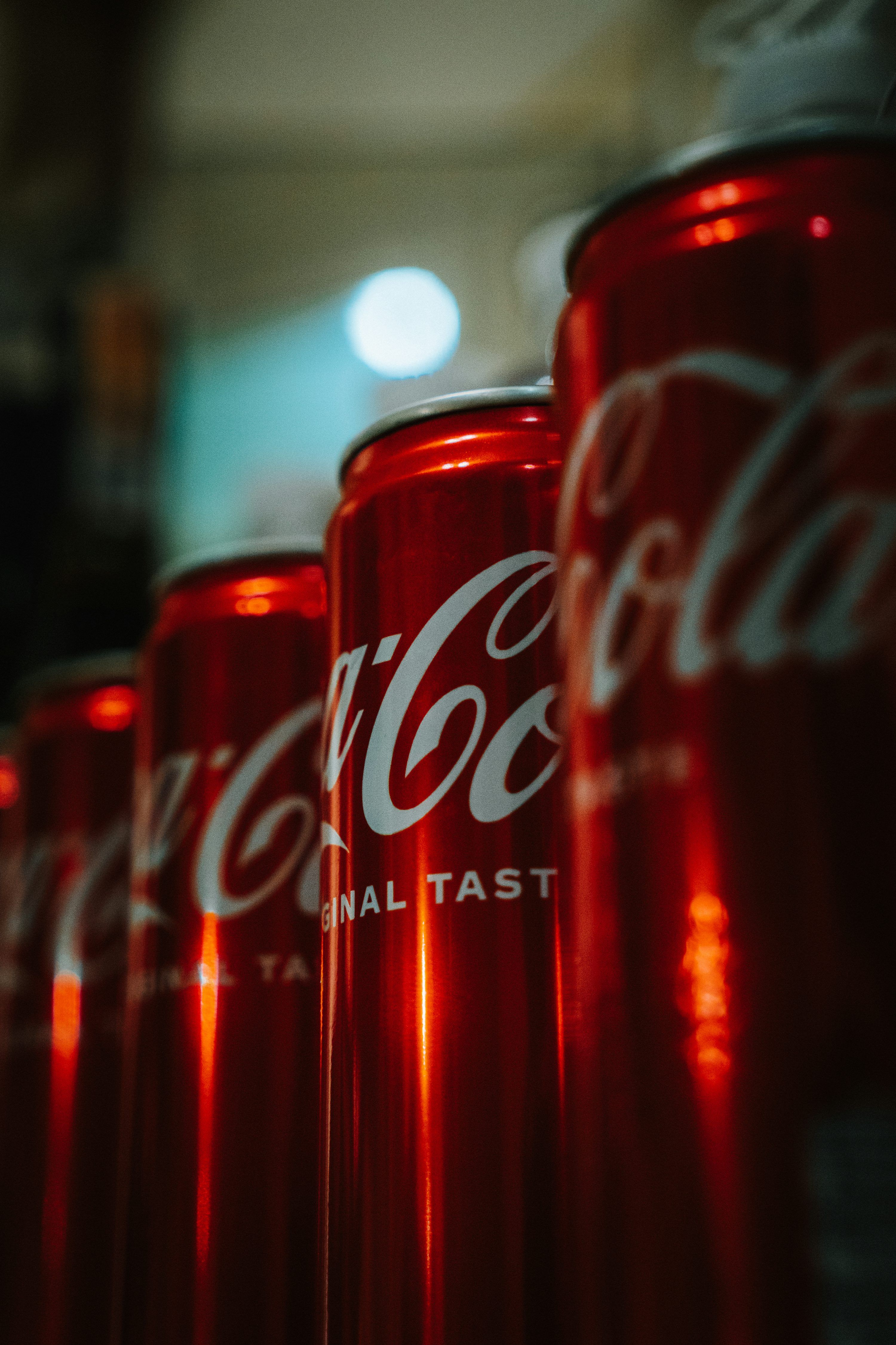 3000x4500 A row of red coca cola cans sitting next to each other photo