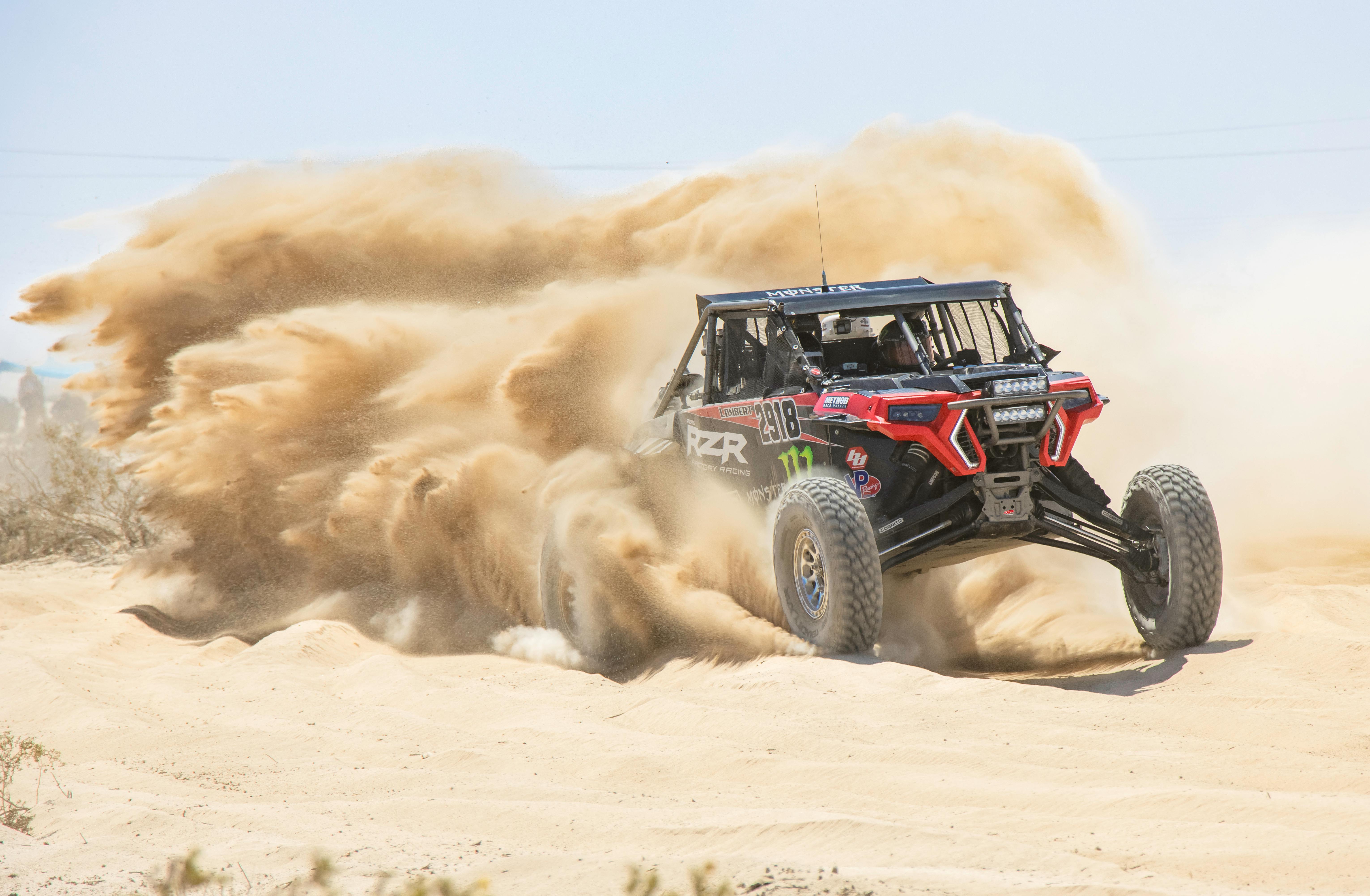 6124x4008 Rally Vehicle Driving Fast in a Desert Leaving a Dust Cloud behind · Free