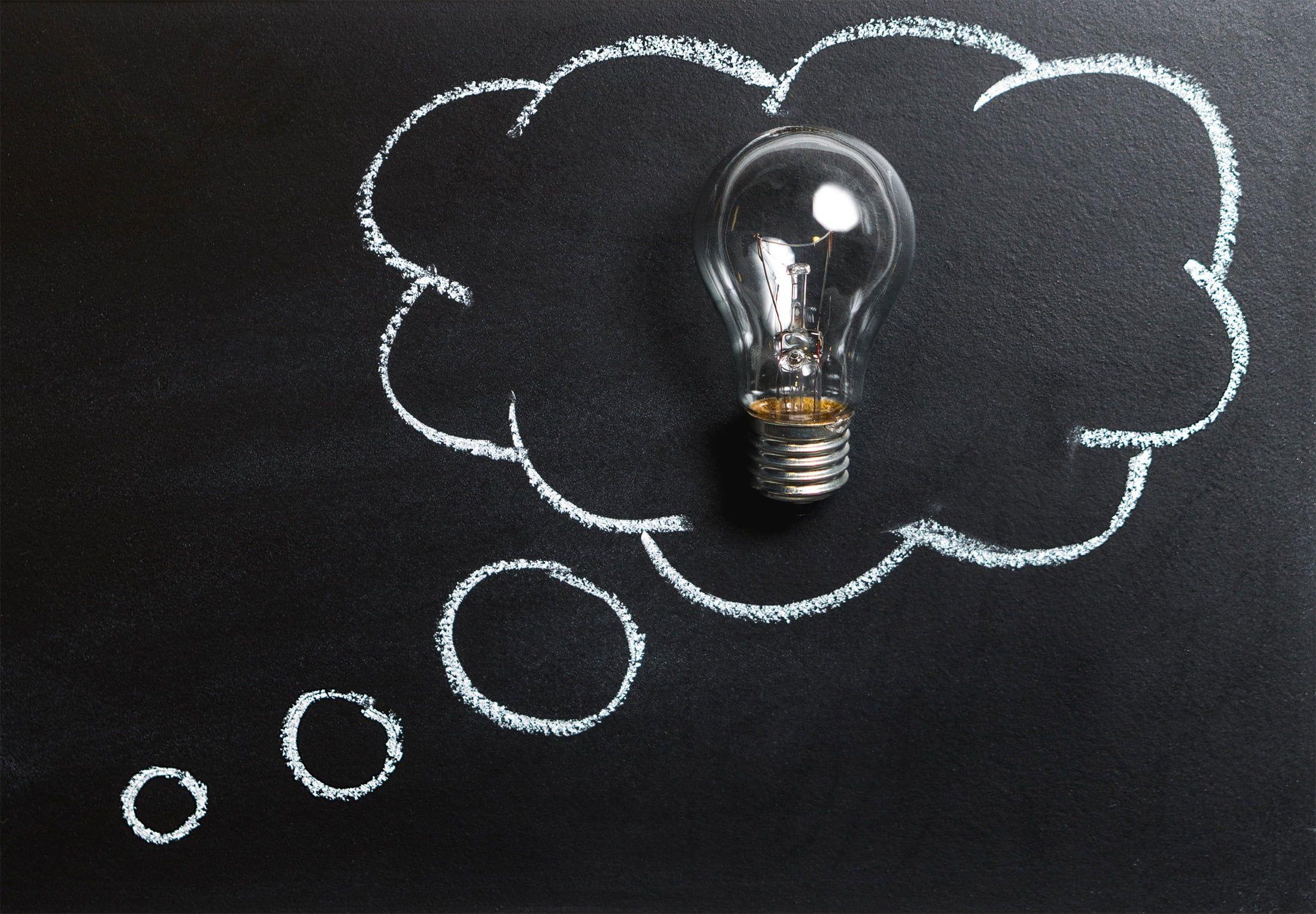 2200x1529 Clear light bulb with dialogue box cloud symbolizing idea sketch