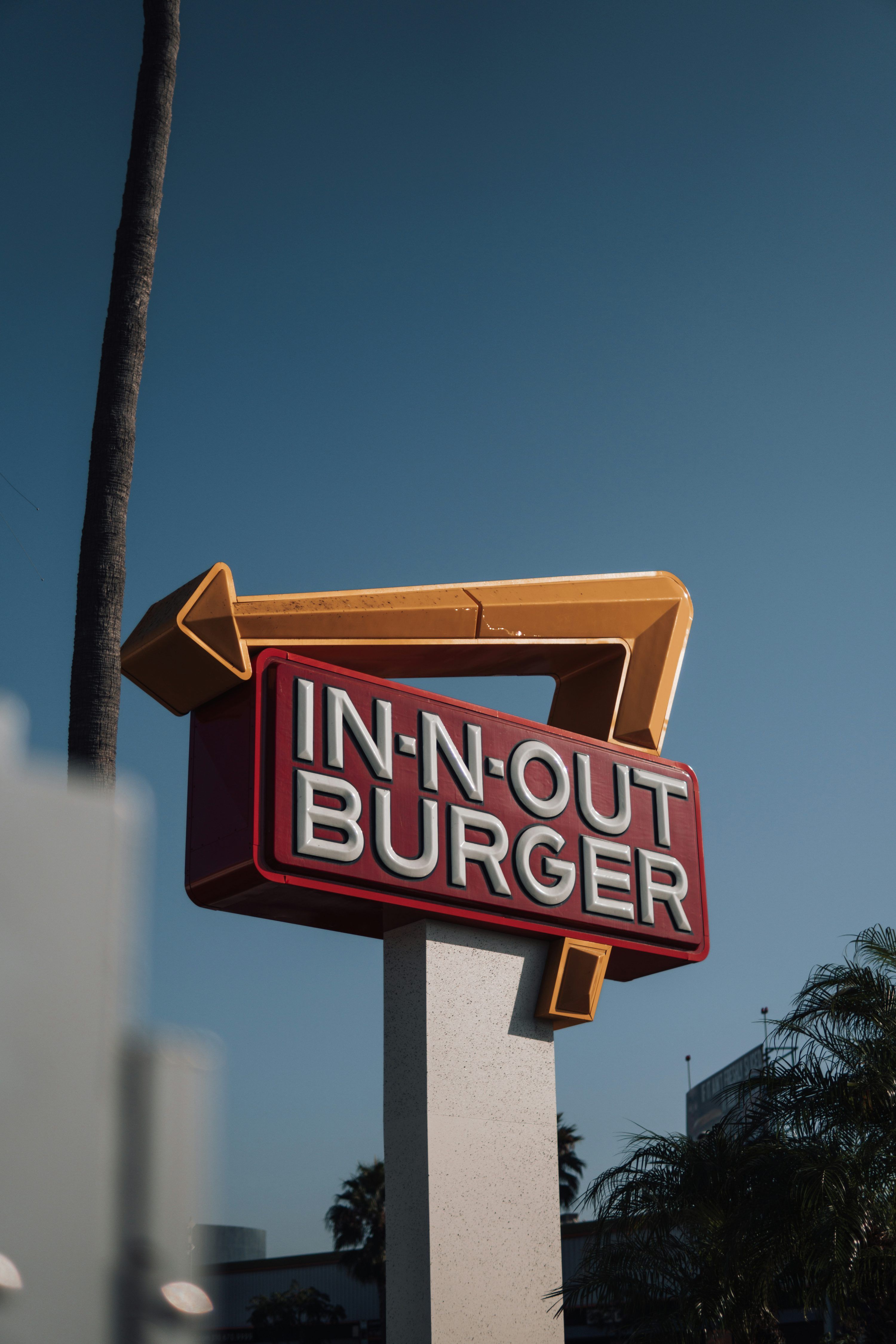 3000x4500 A man standing in front of a fast food restaurant photo