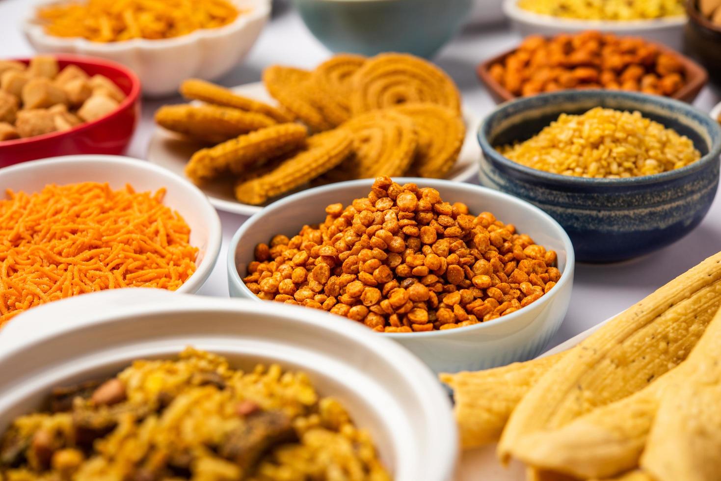 1469x980 Indian Tea time snacks in group. Sev, chivda, farsan, mixture, bakarwadi served in different bowls