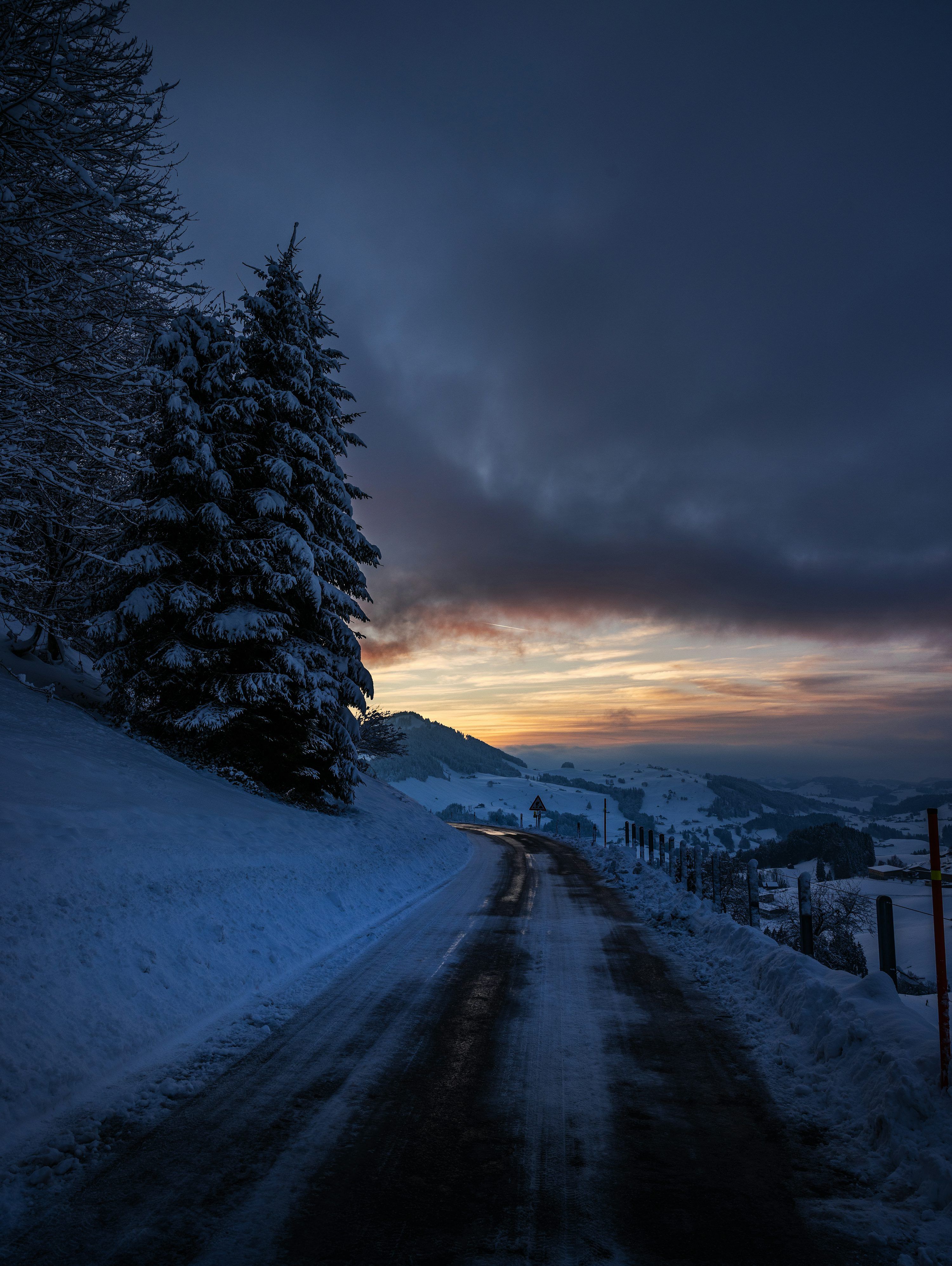 3000x3989 Snowy road through a winter landscape at dusk photo