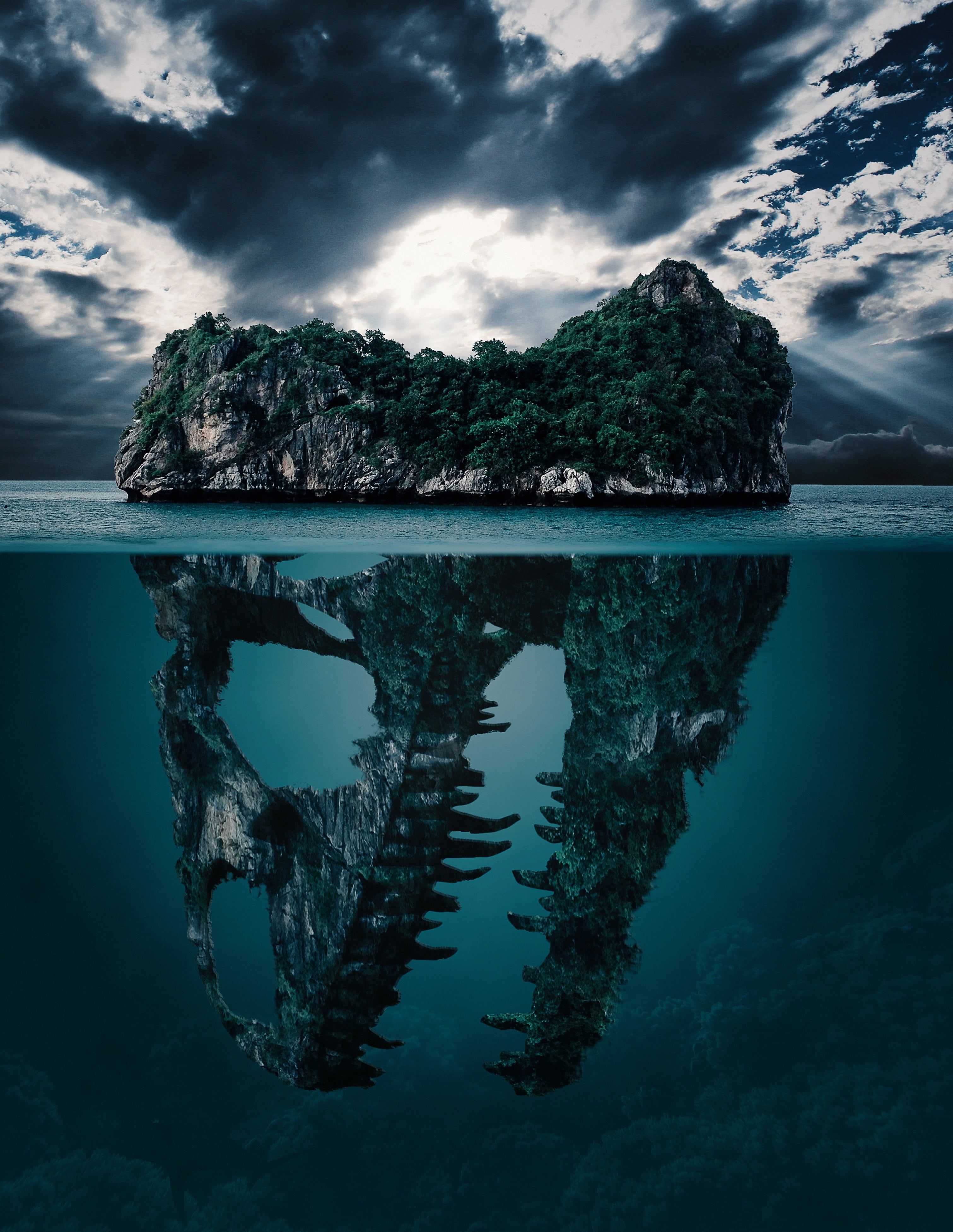 3022x3907 Royalty Free Photo: Green Leaf Trees With Dinosaur Skull Island On Body Of Water