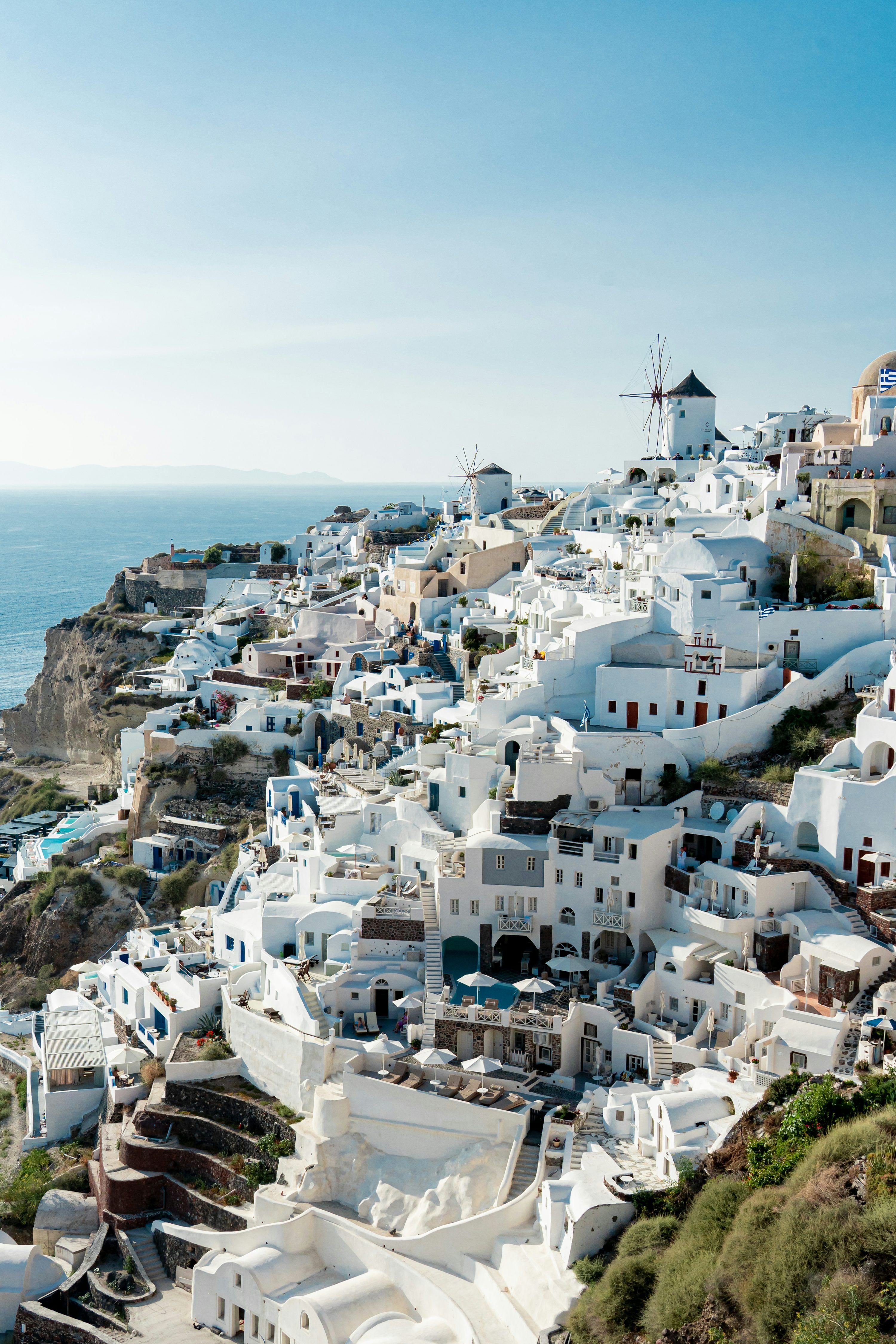 3000x4500 White buildings perch on a cliff overlooking the sea. photo