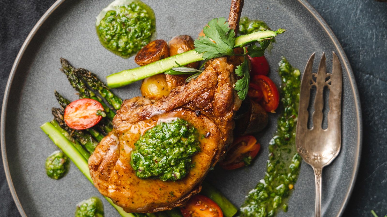 1600x900 Rosemary Pork Chop with Chimichurri, Roasted Baby Potatoes and Asparagus