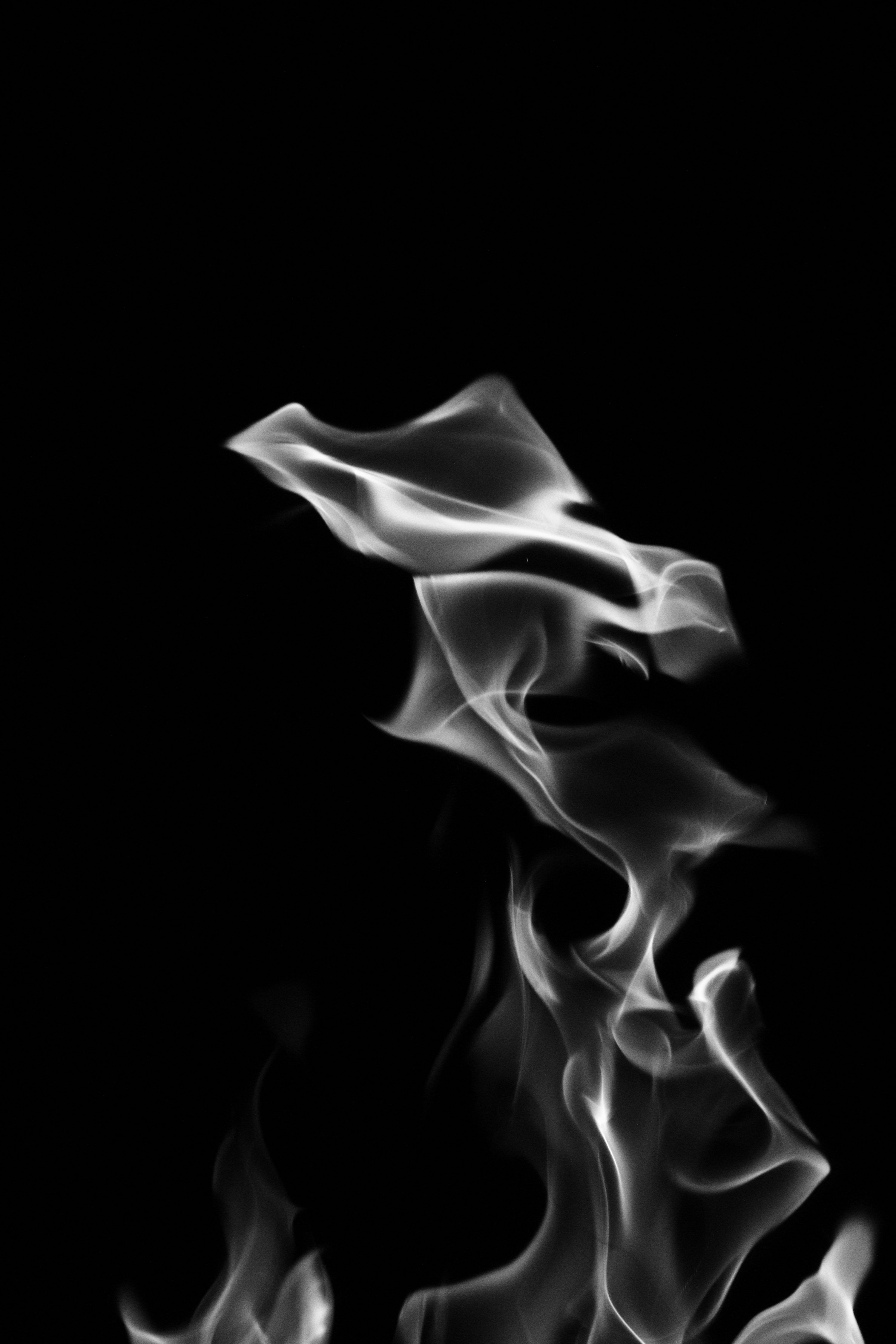 3000x4500 White smoke rises against a black background. photo