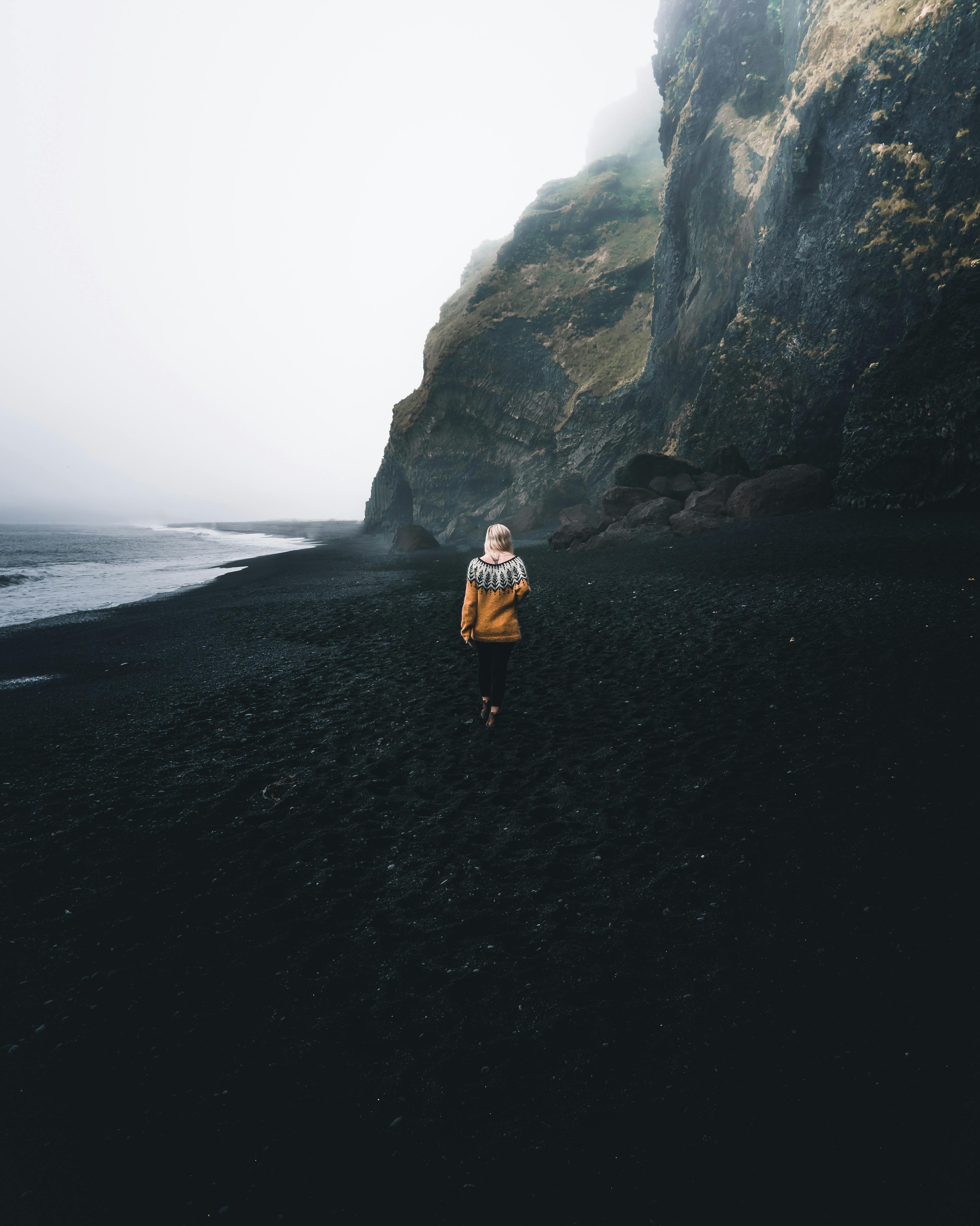 3754x4693 Back View of a Woman Walking on Black Sand · Free