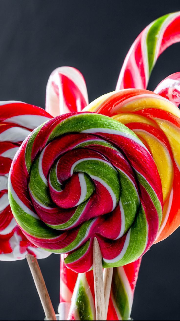 736x1308 Colorful lollipops on a black background