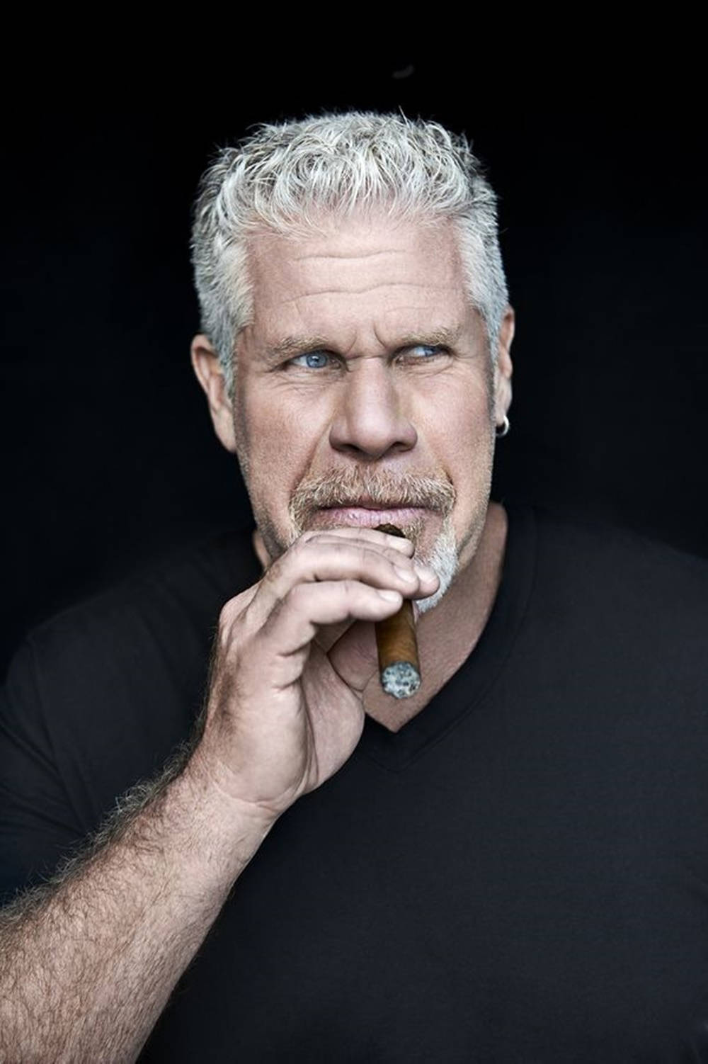 1000x1502 Download Hollywood Icon Ron Perlman Puffs on a Giant Cigar Wallpaper